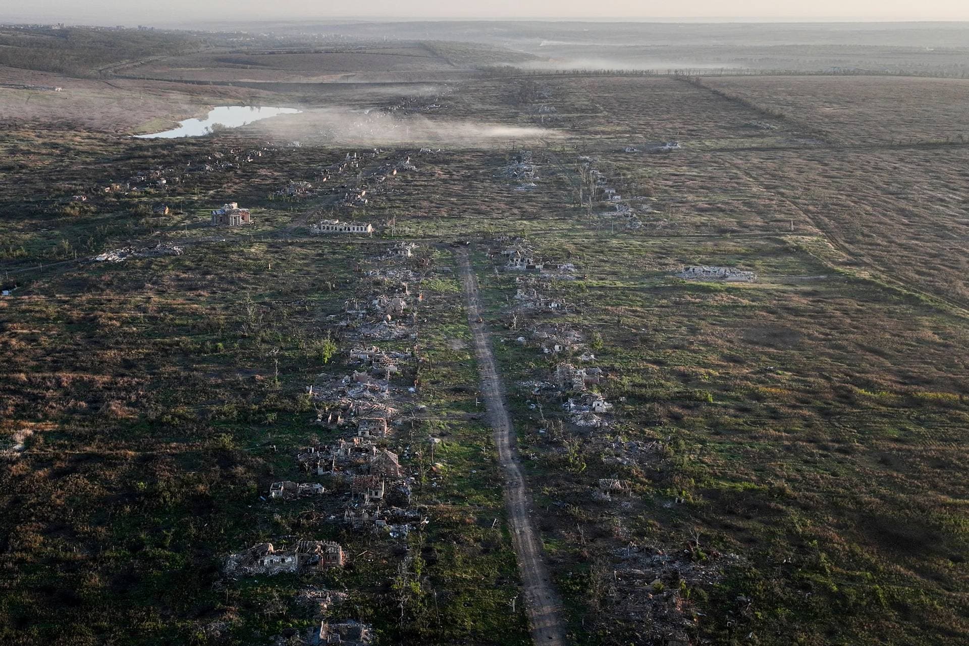 A destroyed tank is seen from the window of an armored vehicle near Klishchiyivka