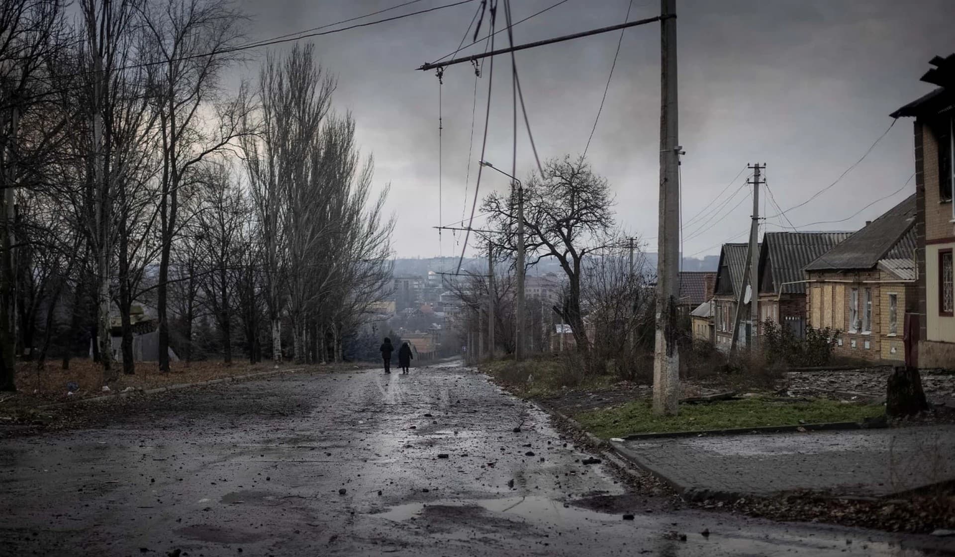Local residents walk down a street in Bakhmut