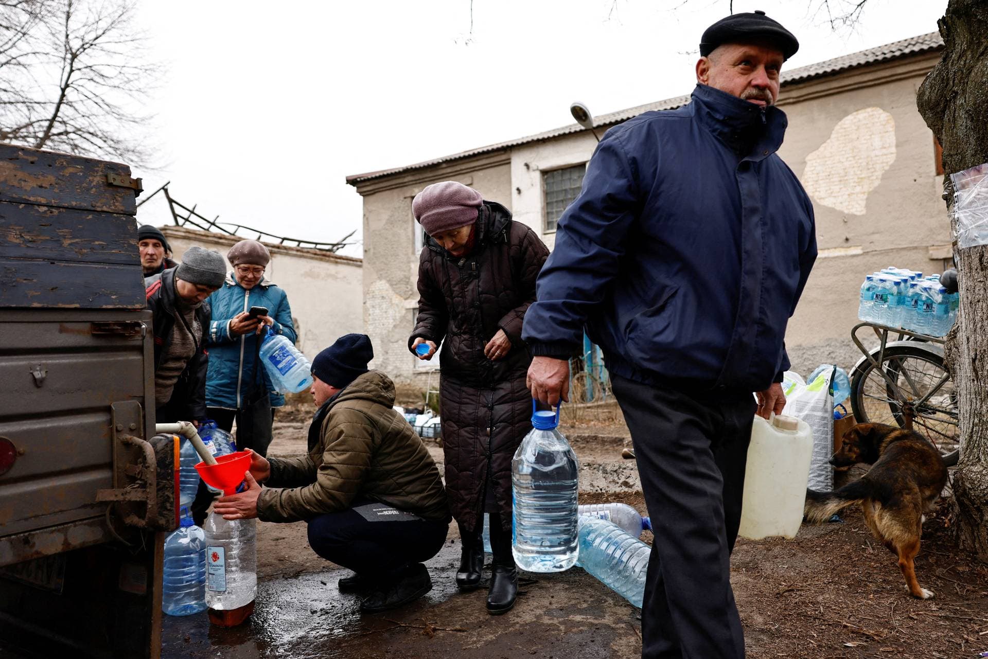 Residents fill up bottles with fresh drinking water brought into Chasiv Yar