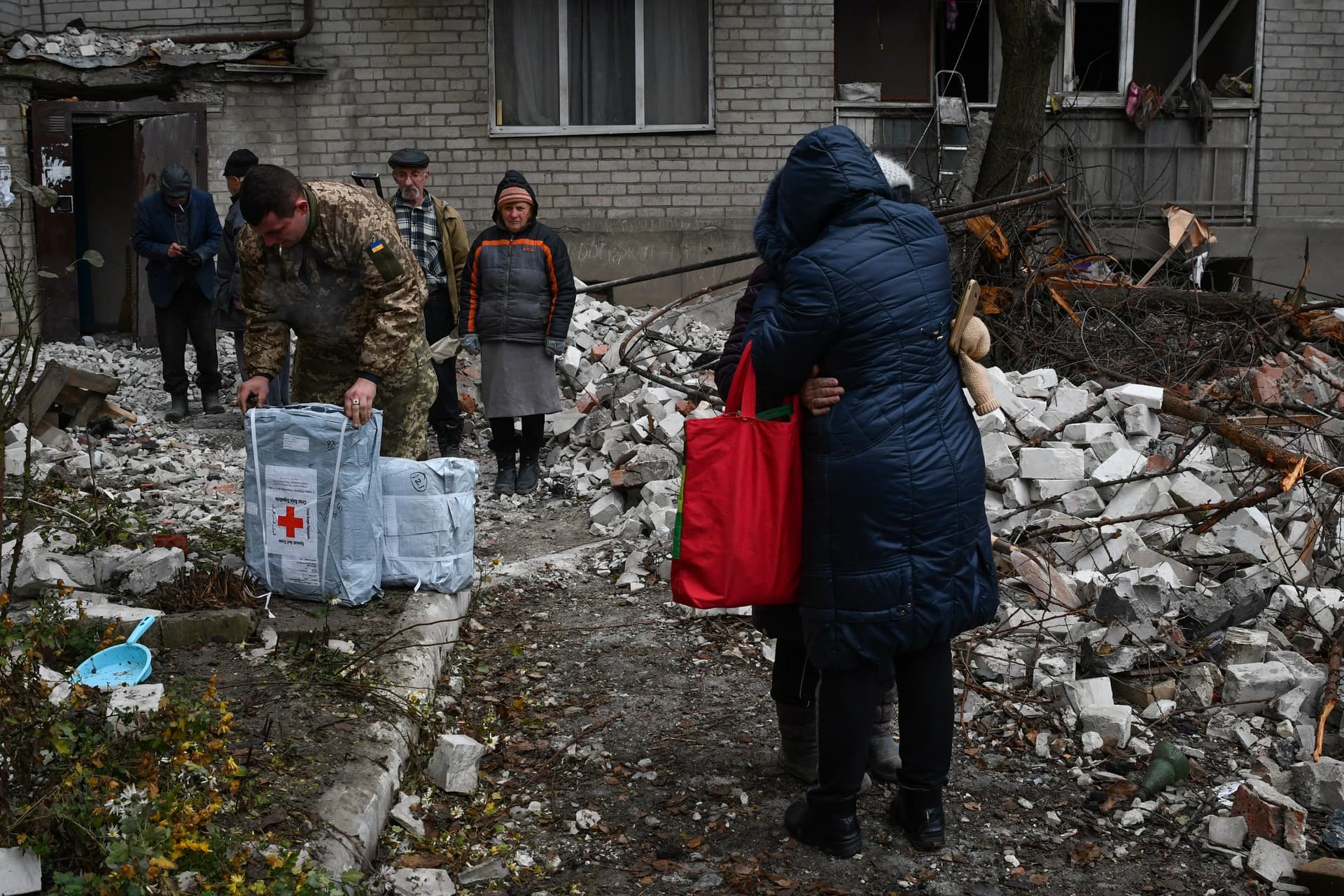 Local residents react near the destroyed house after recent Russian air strike in Chasiv Yar
