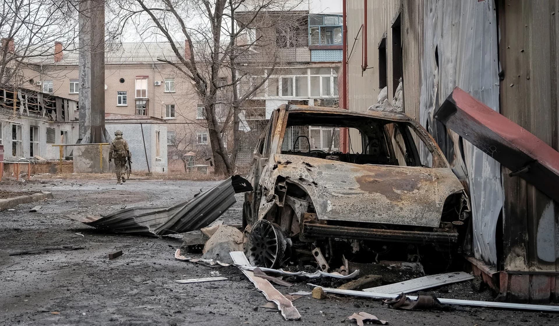 A Ukrainian serviceman walks an empty street as he patrols in the front line city of Bakhmut