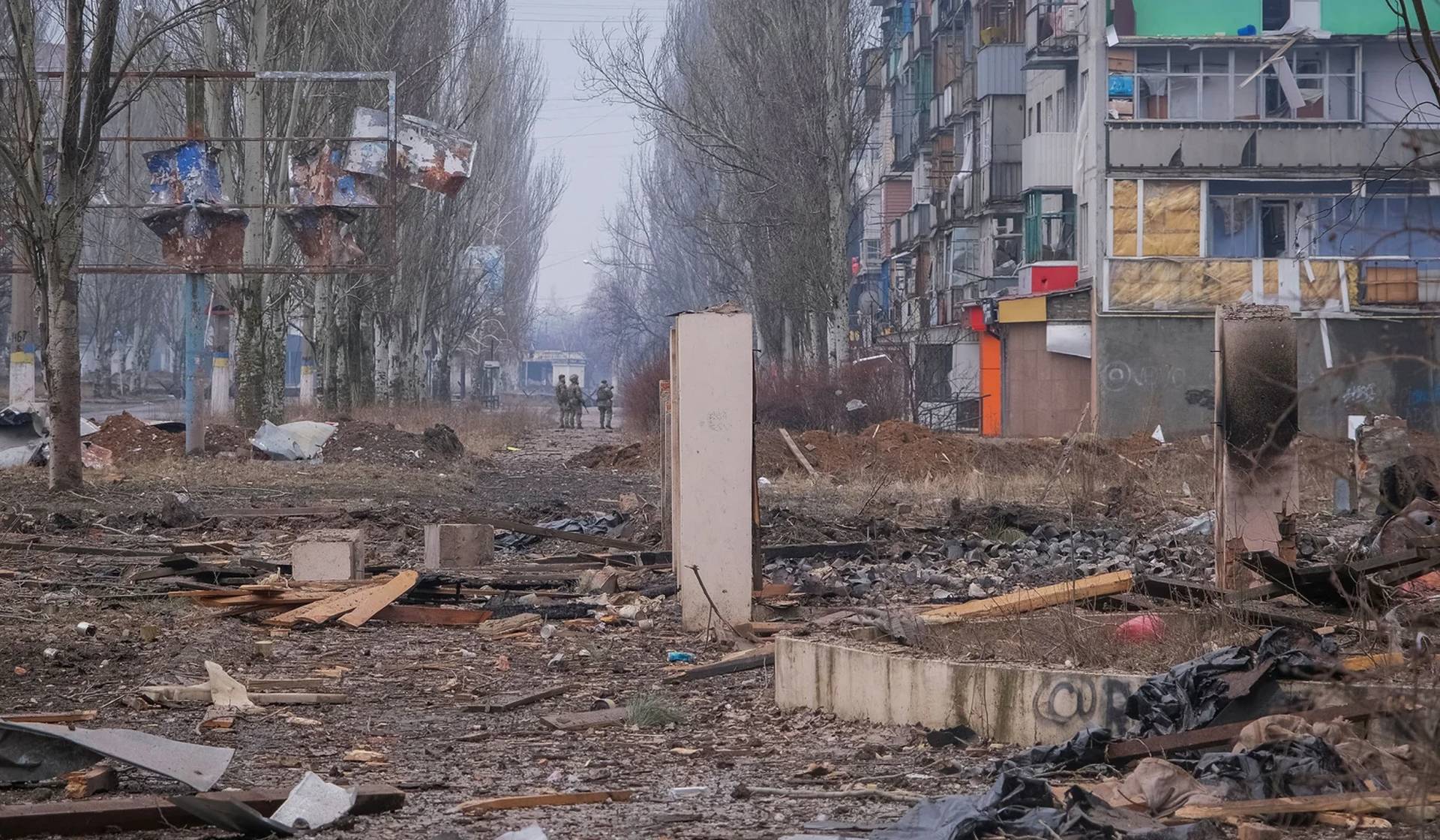 Ukrainian service members on an empty street in the frontline city of Bakhmut