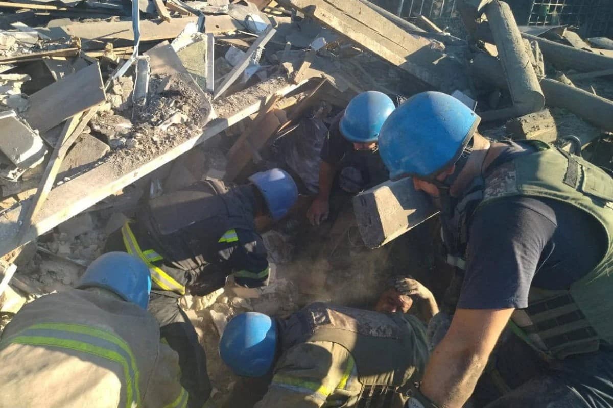 Rescuers release a man from ruins of a residential building destroyed by a Russian military strike in the town of Toretsk