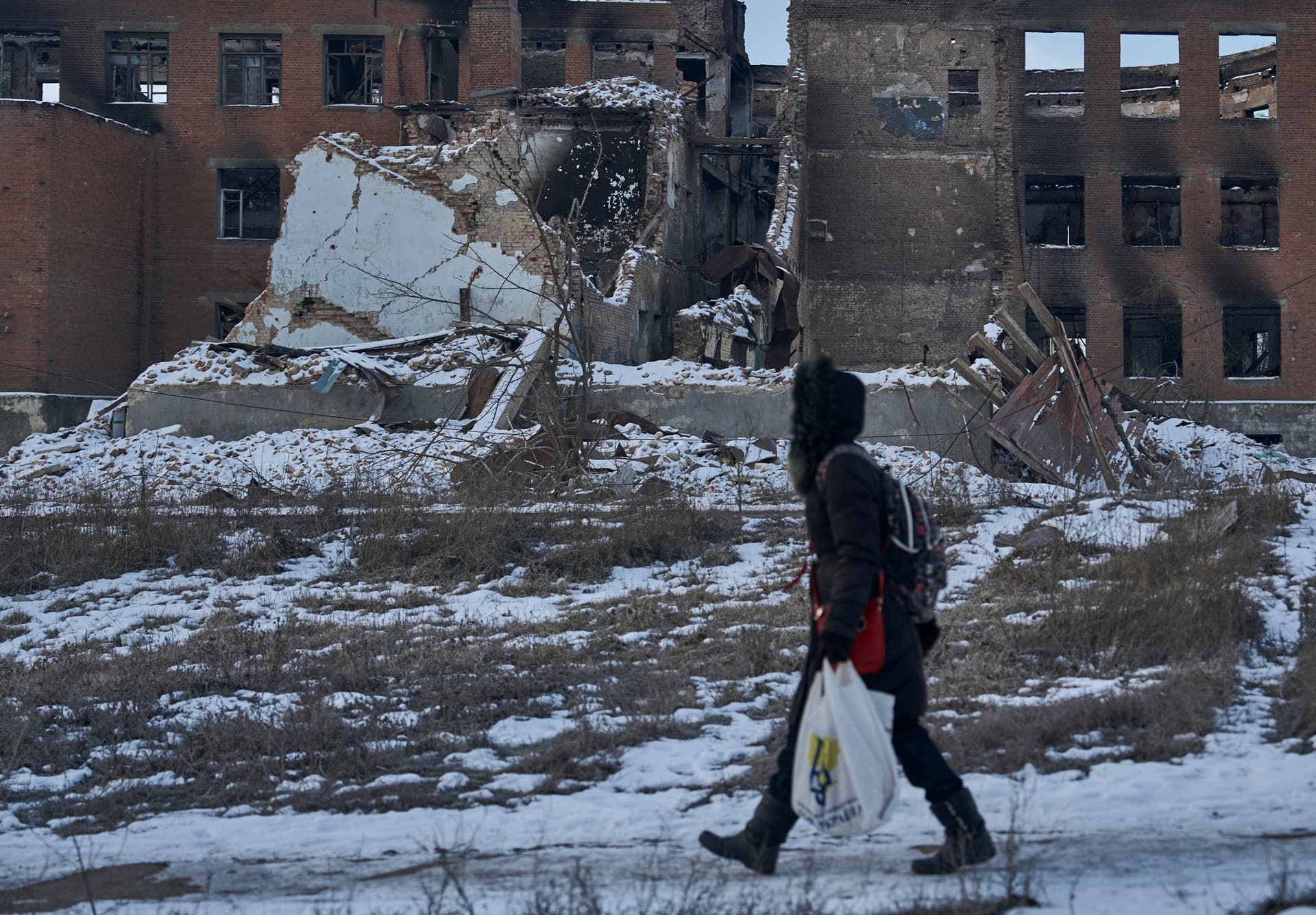 A local resident walks along a street in Bakhmut