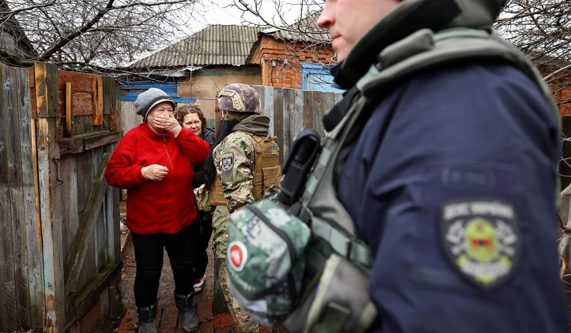 A woman refuses to be evacuated while firefighters of unit Phoenix and Police work to evacuate residents near the frontline in Siversk