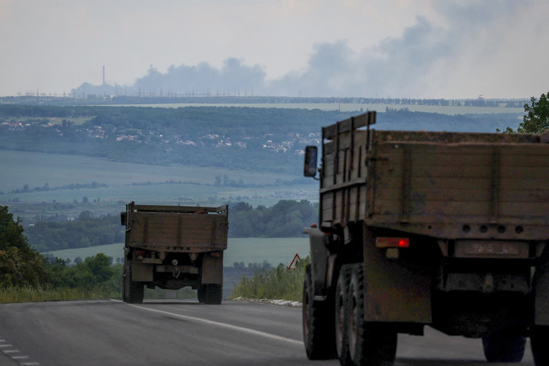 Ukraine's second-biggest power plant, Vuhlehirsk, burns in the distance near the town of Svitlodarsk