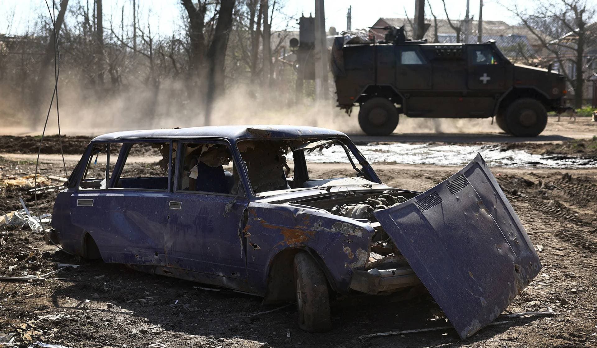 An armored military vehicle speeds through Chasiv Yar