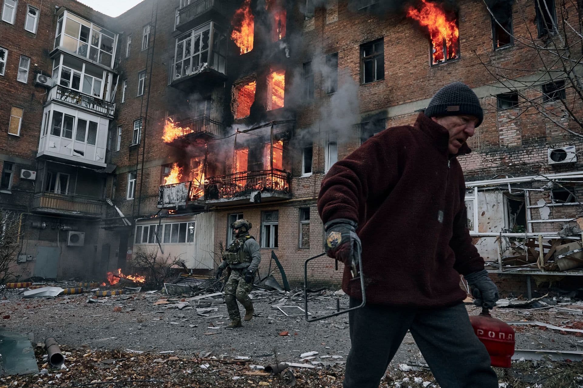 A local resident leaves his home after Russian shelling destroyed an apartment house in Bakhmut