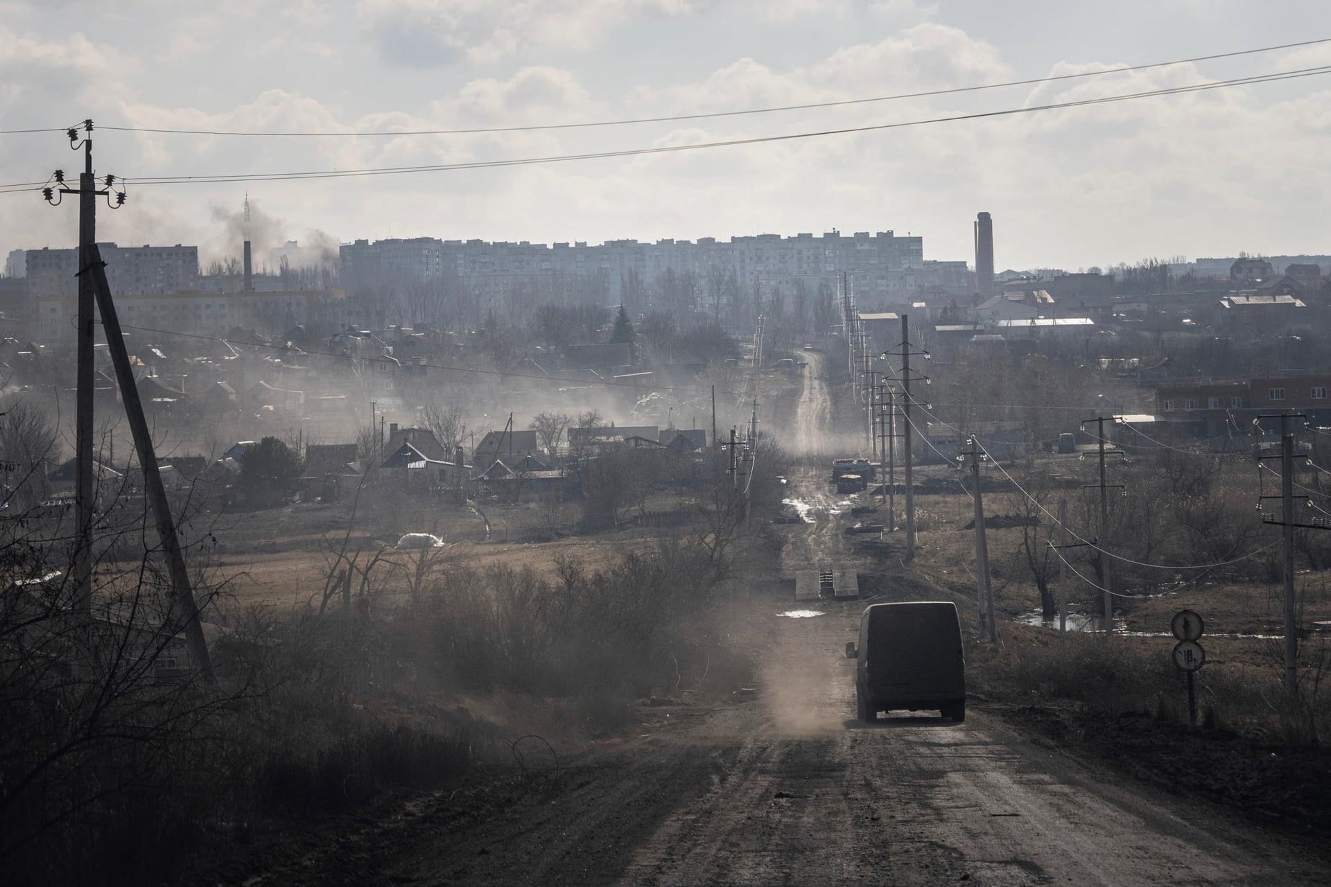 Ukrainian service members on an empty street in the frontline city of Bakhmut