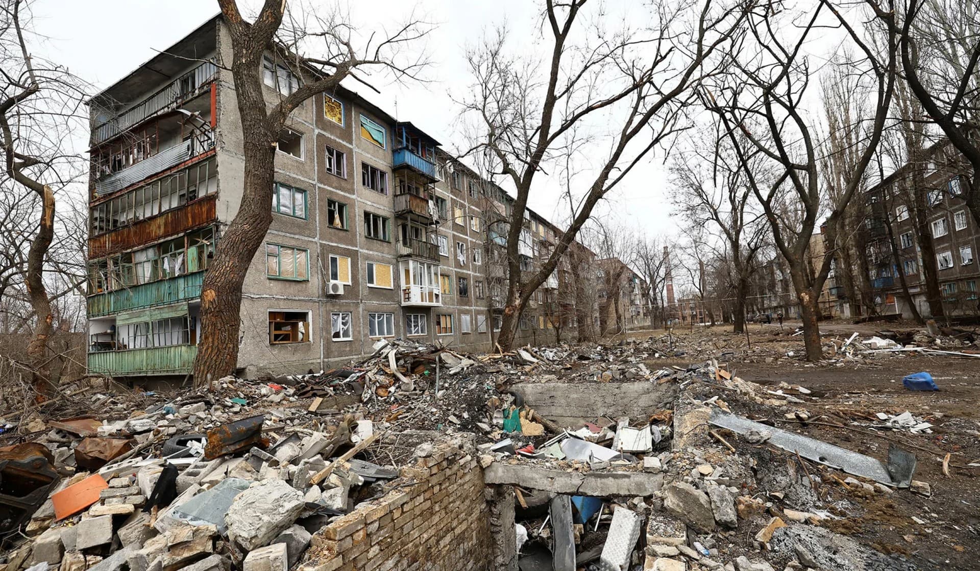 Debris near a damaged residential building in Chasiv Yar