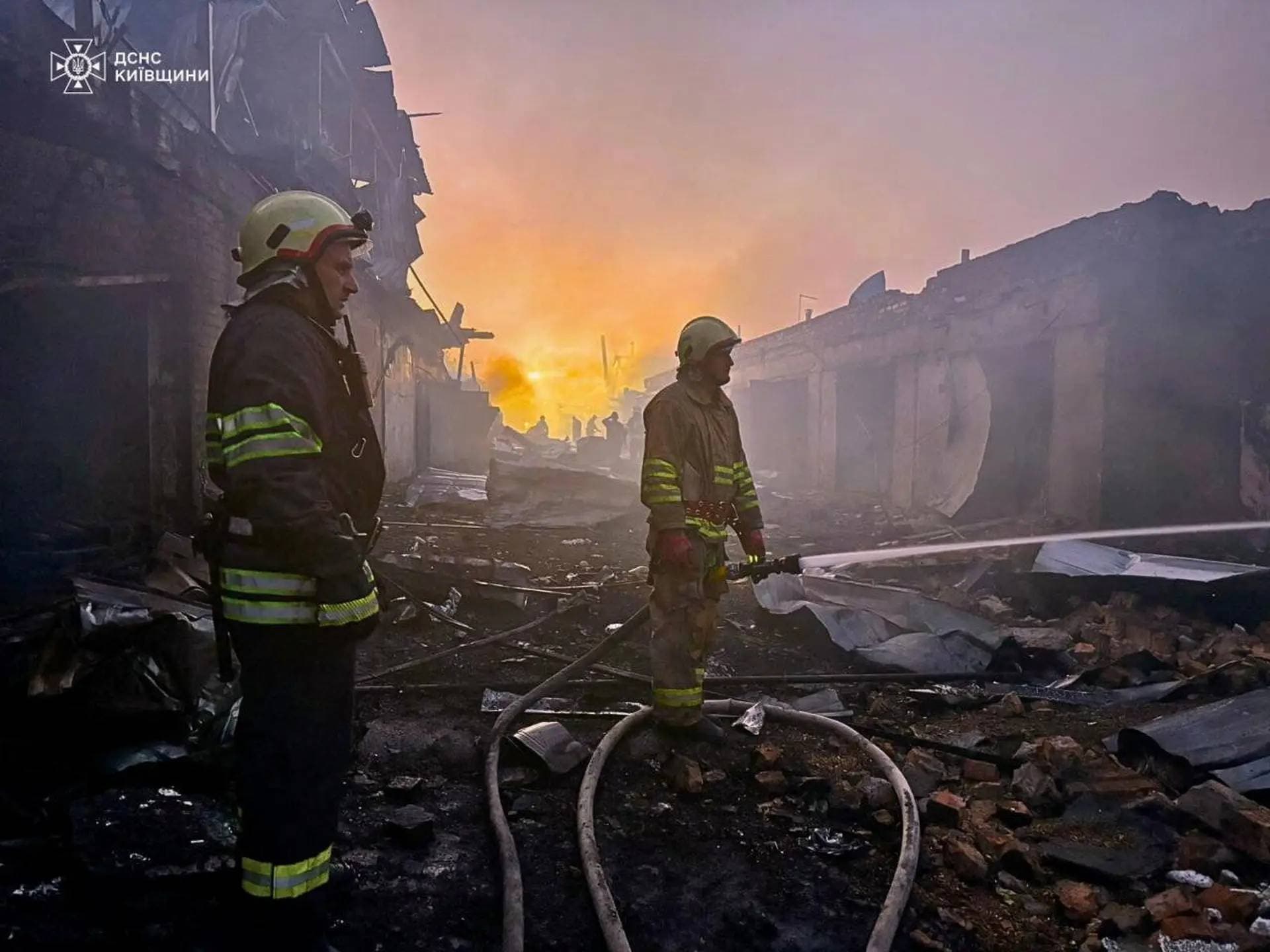 Firefighters work at the site of car garages hit by a Russian drone strike in Bila Tserkva