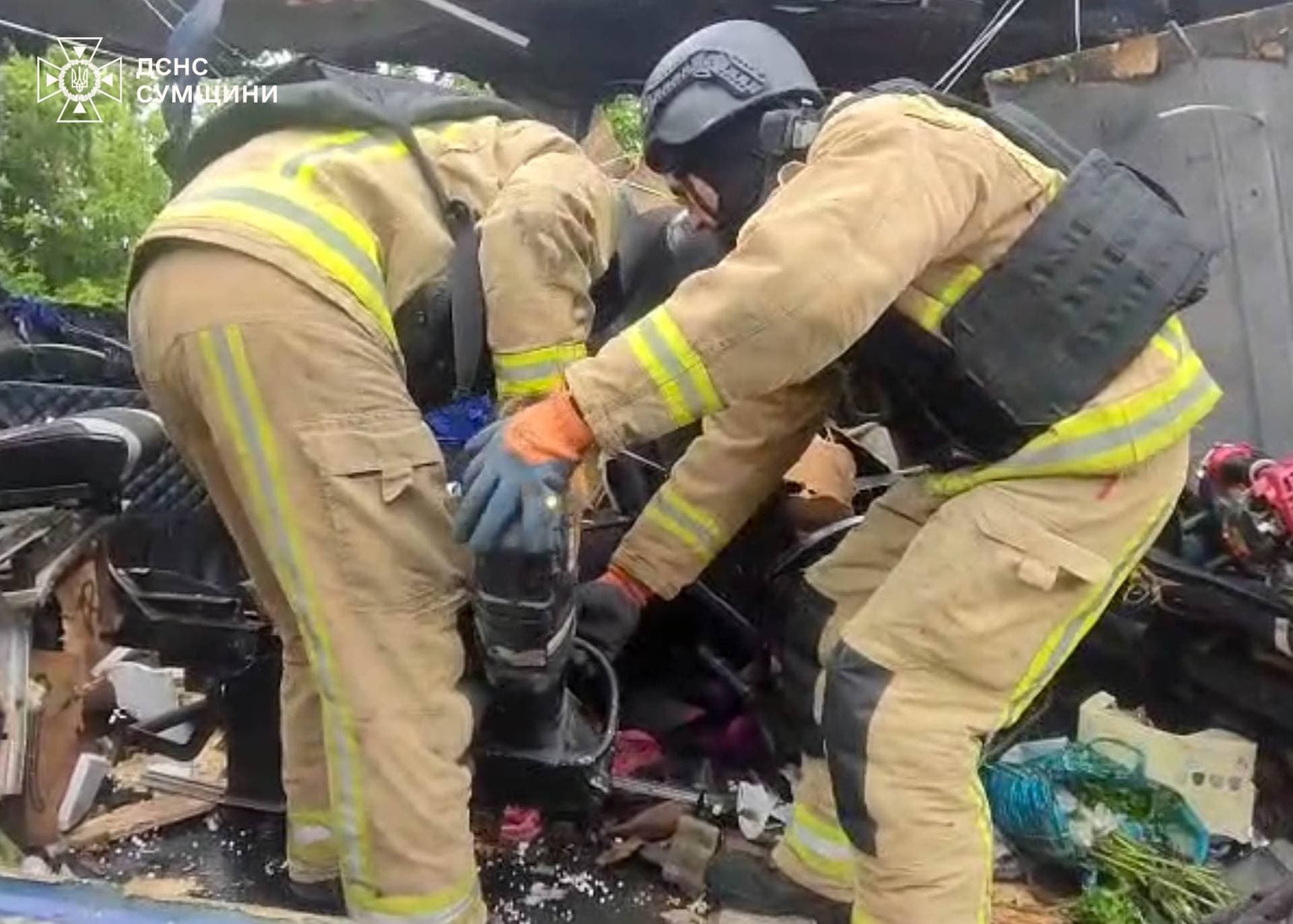 Emergency officers carry out rescue operations after a Russian strike on a van in Bilopillia
