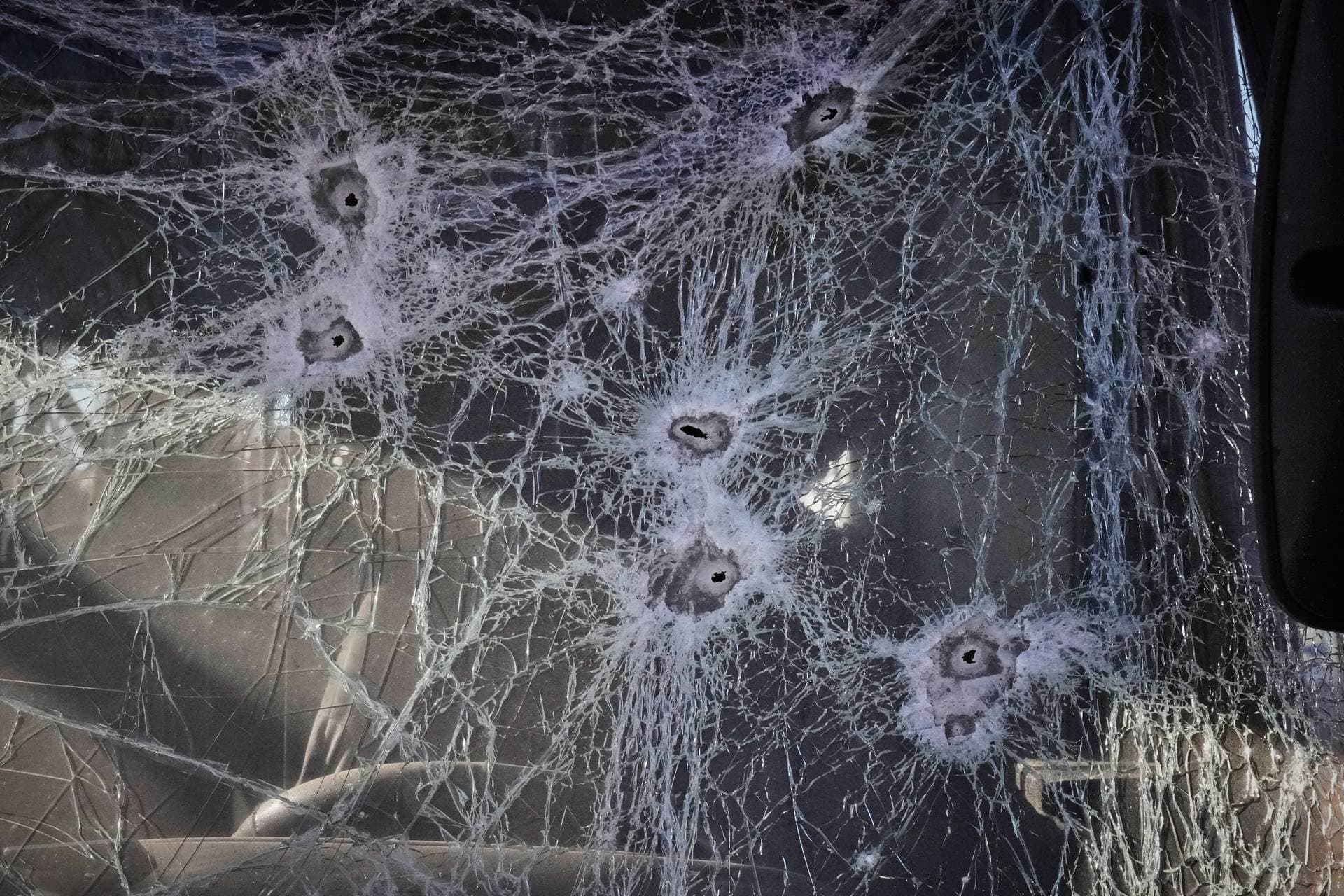 Shrapnel holes cover the glass of a damaged bus near railway workshops, following a Russia missile and drone attack, in Brovary