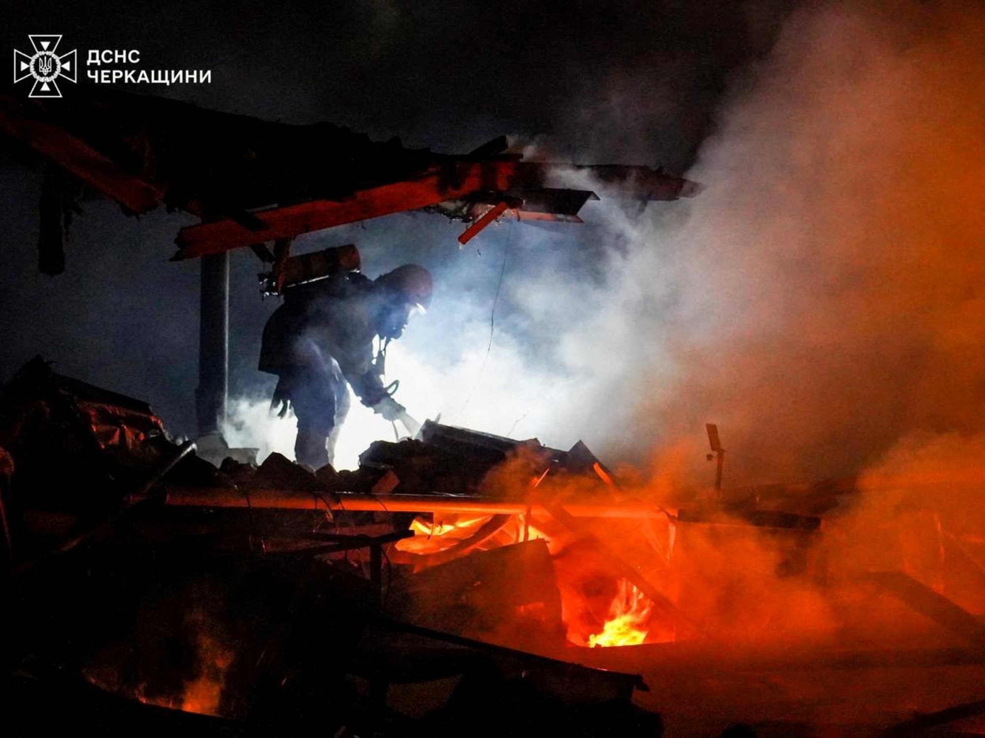 A firefighter works at a site of a Russian missile and drone strike in Cherkasy Region