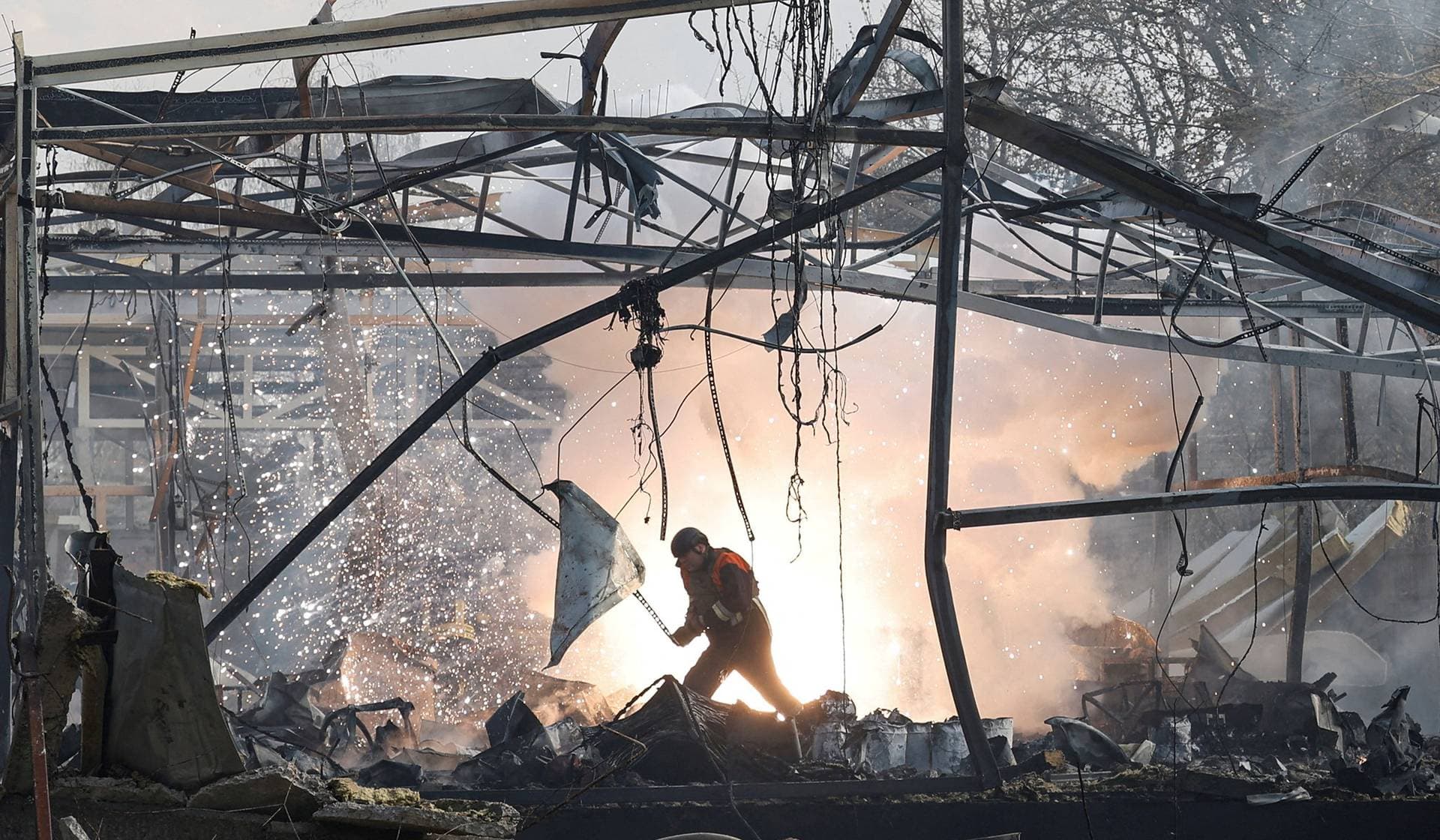 A firefighter inspects a compound of a private enterprise hit by a Russian missile strike in Chernihiv