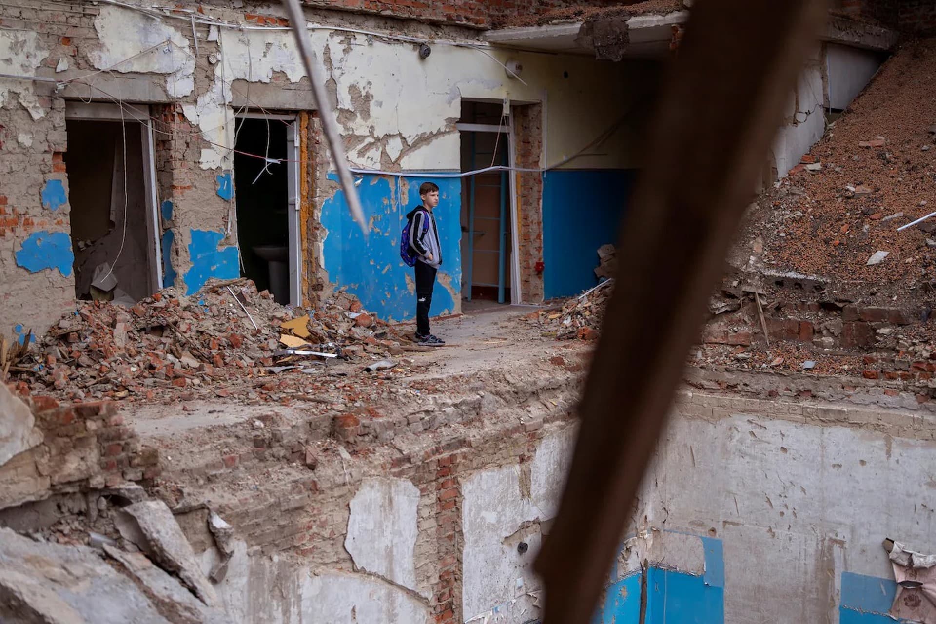 Mykola Kravchenko looks at his computer class destroyed at Mykhailo-Kotsyubynske's lyceum, which was bombed by Russian forces on March 4, in Chernihiv