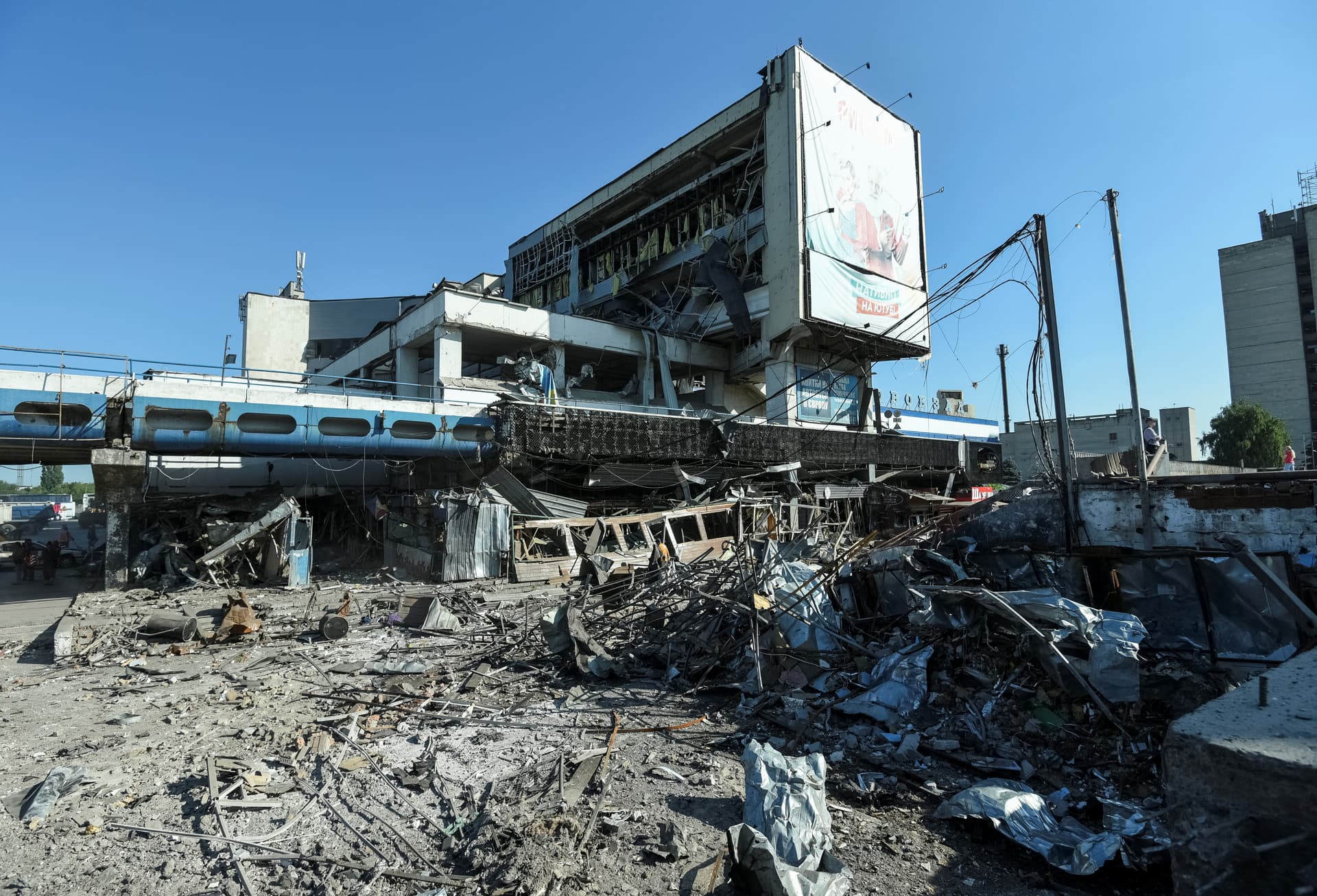 Communal workers clean at the site of a area destroyed during a Russian military strike in Dnipro