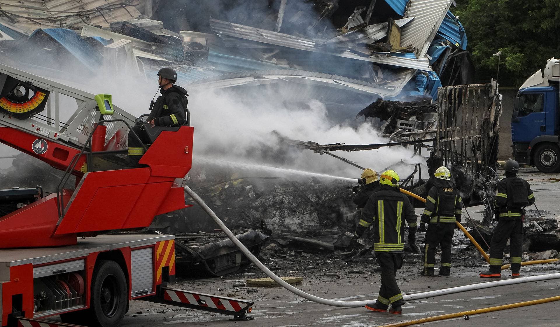 Firefighters work at a site of a Russian drone strike in Dnipro