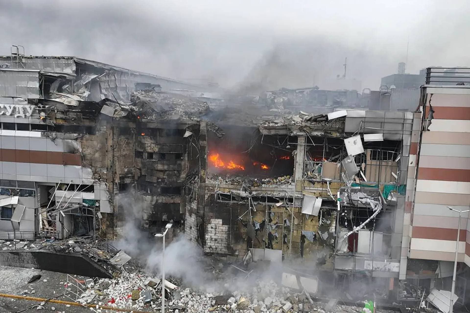 Firefighters work in the ruins of a shopping centre damaged in Dnipro