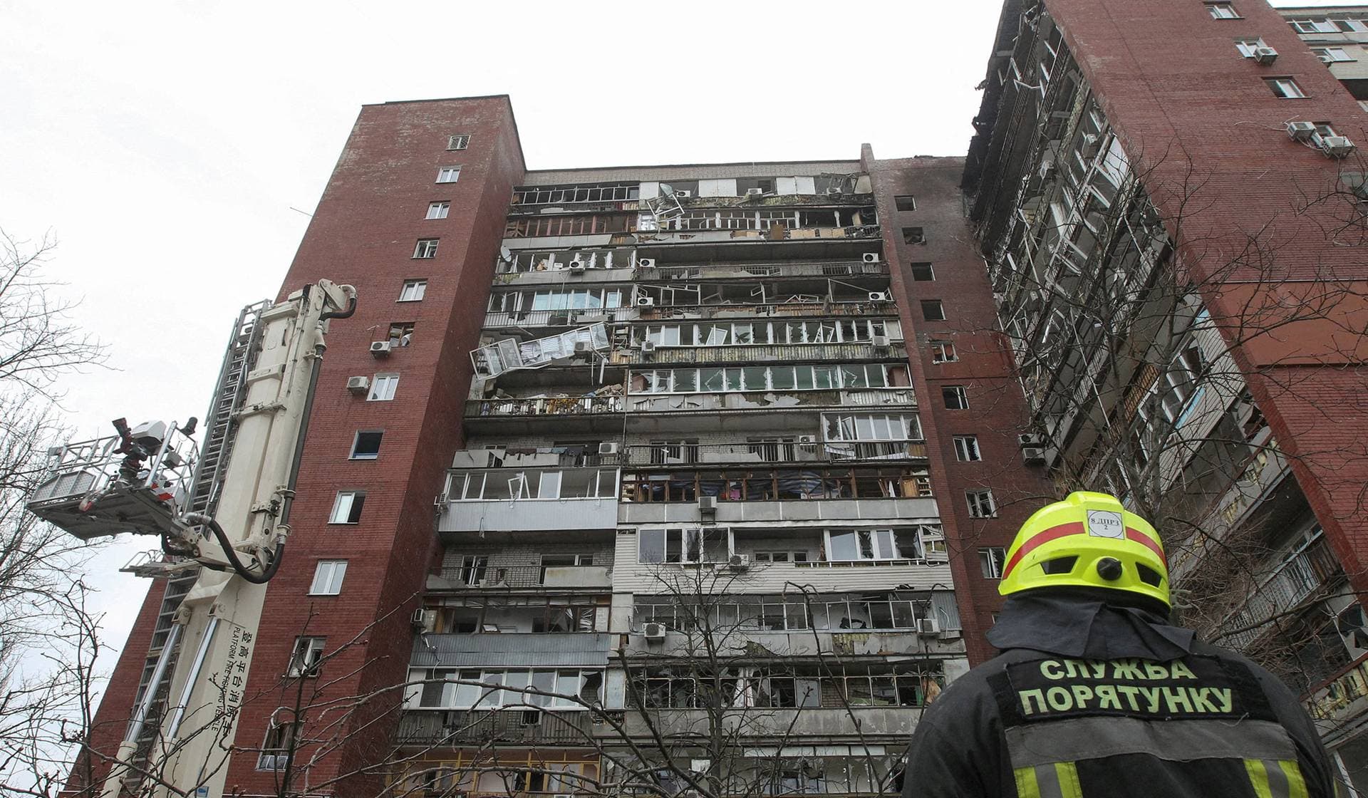 Rescuers work at the site of an apartment building which was hit by a Russian drone strike in Dnipro