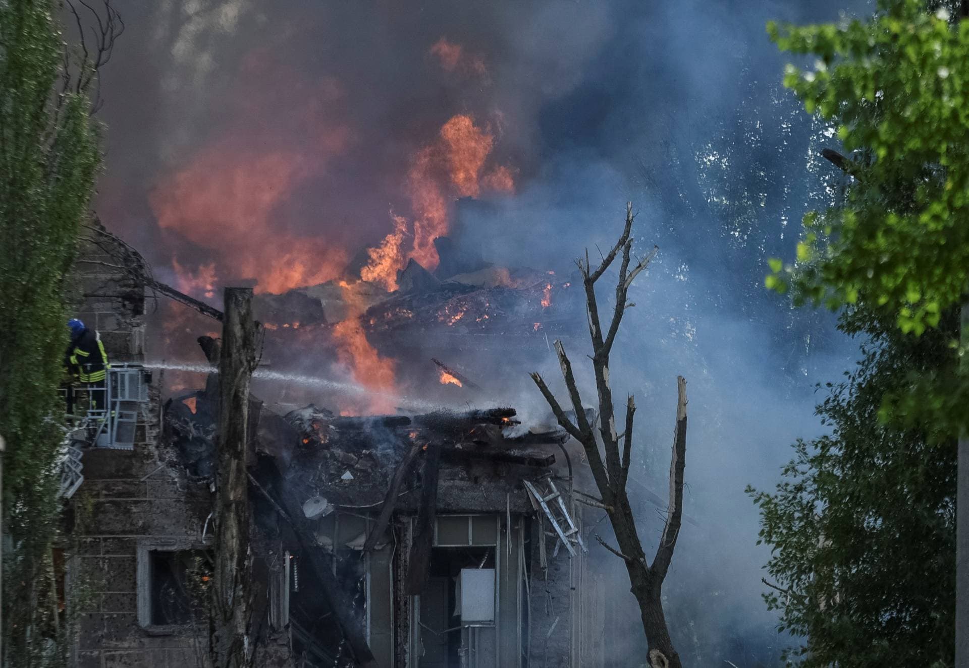 Rescuers works at a site of a clinic heavily destroyed by a Russian missile strike in Dnipro