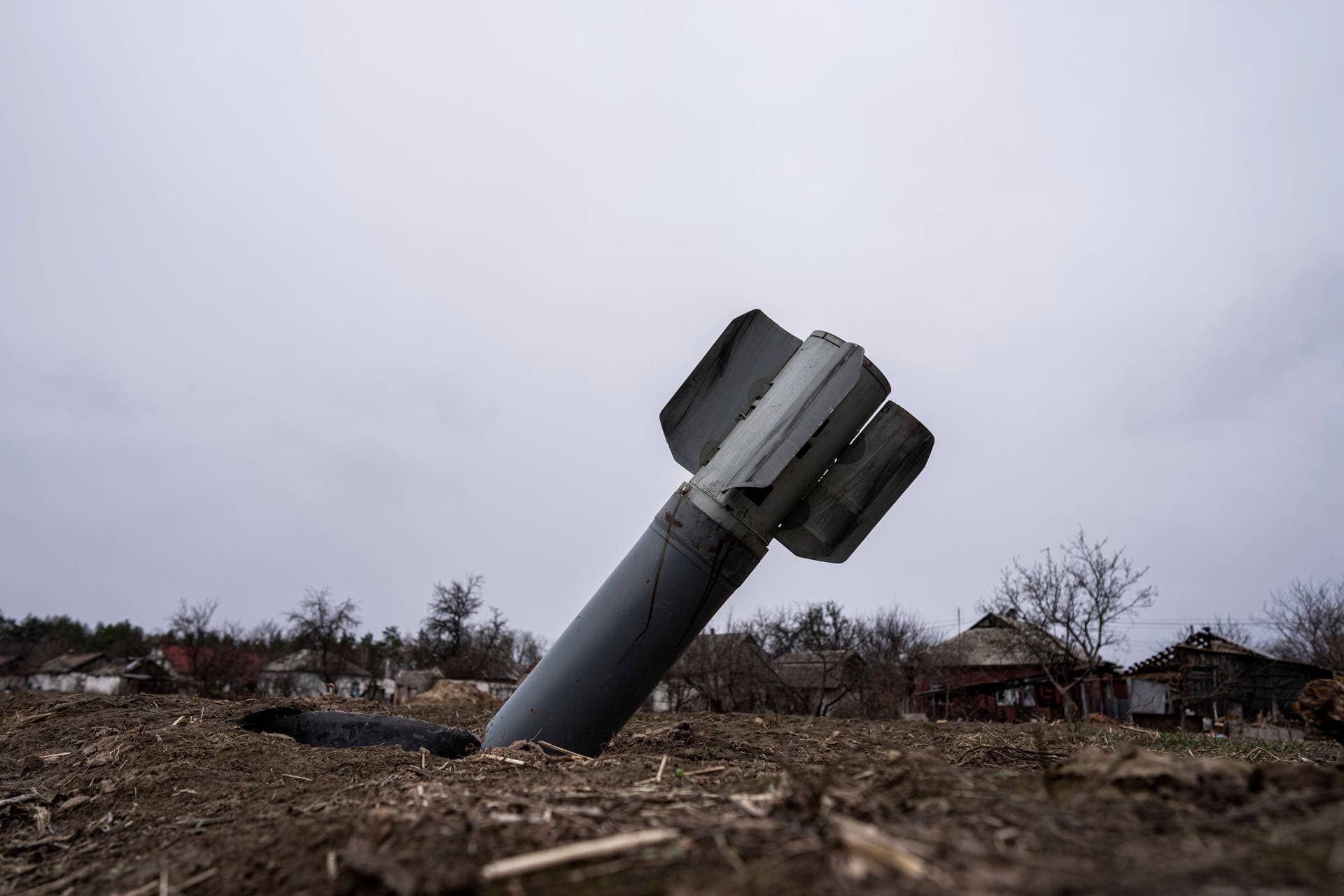 The tail of a missile sticks out in a residential area in Yahidne