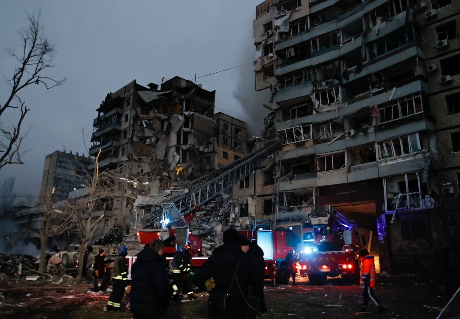 Emergency workers clear the rubble after a Russian rocket hit a multistory building leaving many people under debris in Dnipro