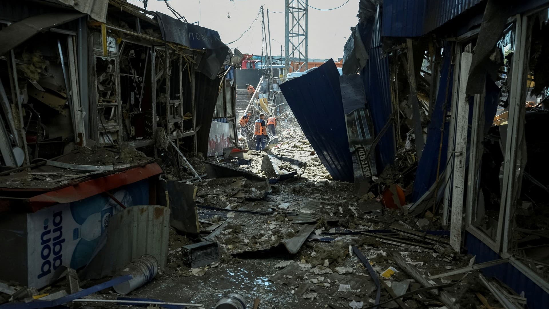 Communal workers clean at the site of a area destroyed during a Russian military strike in Dnipro