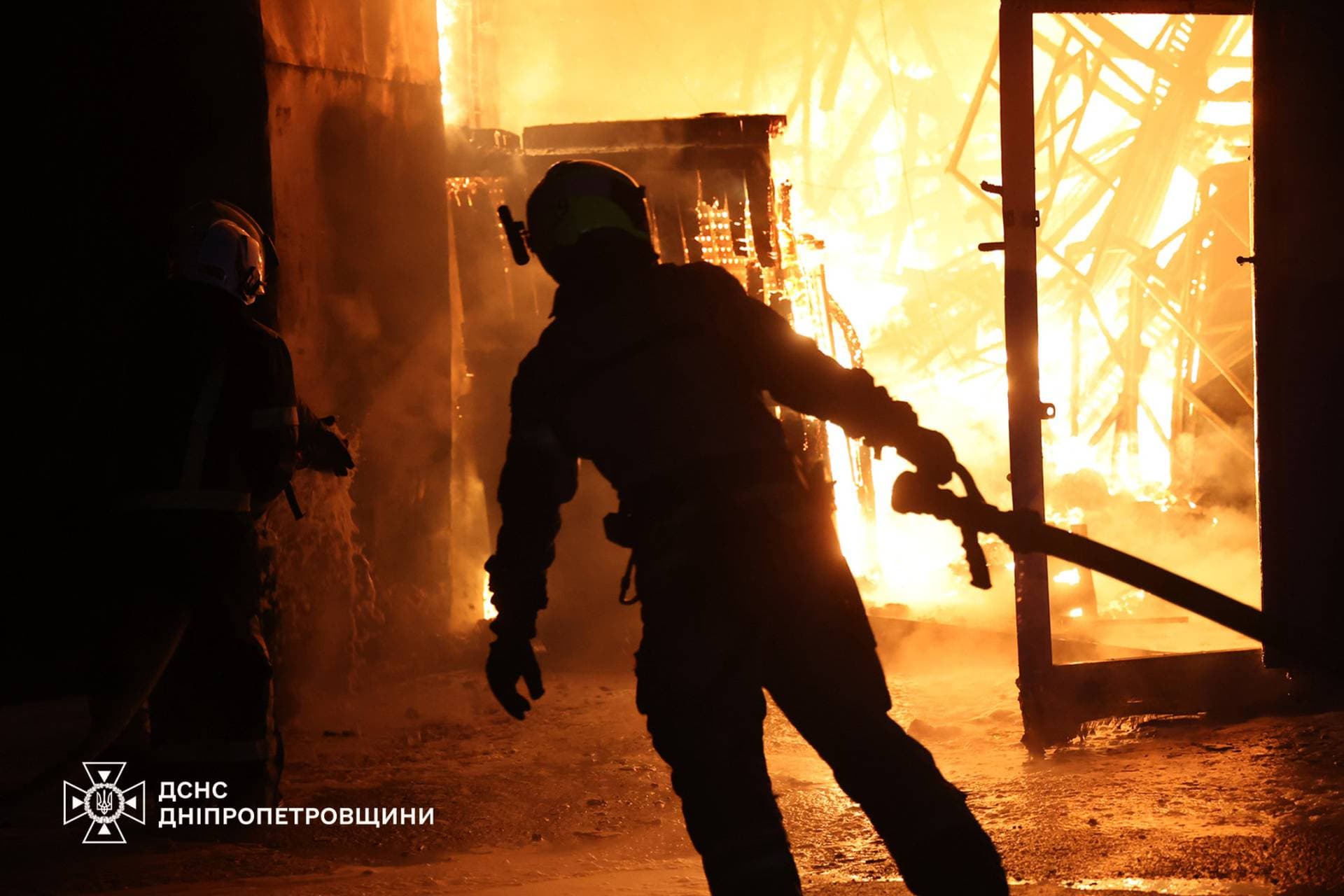 Firefighters work at the site of a Russian military strike in Dnipropetrovsk Region