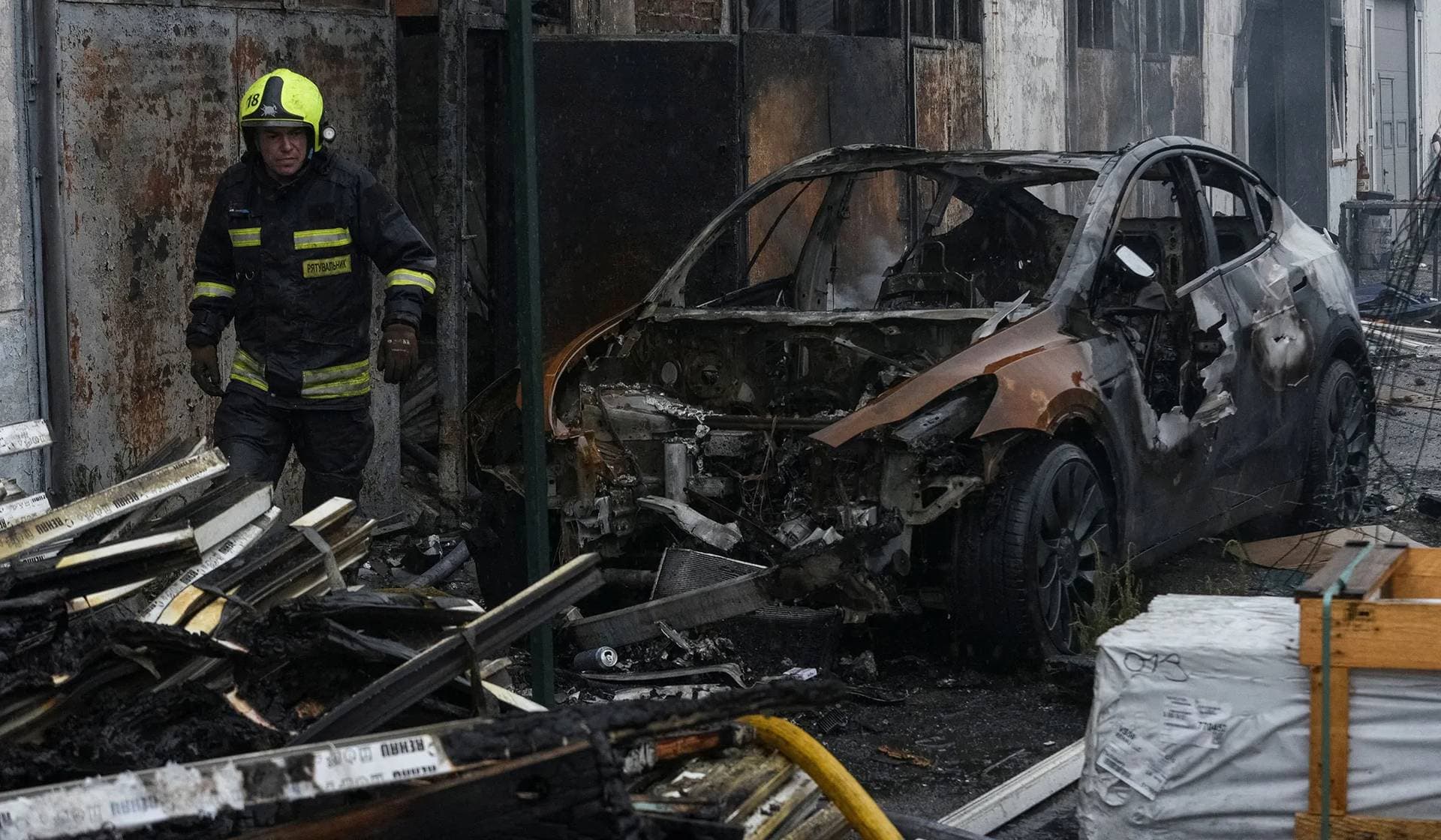 A rescuer walks at the site of a Russian drone strike in Dnipro