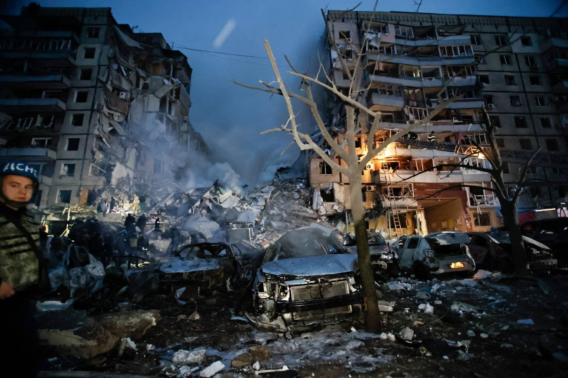 Emergency workers clear the rubble after a Russian rocket hit a multistory building leaving many people under debris in Dnipro