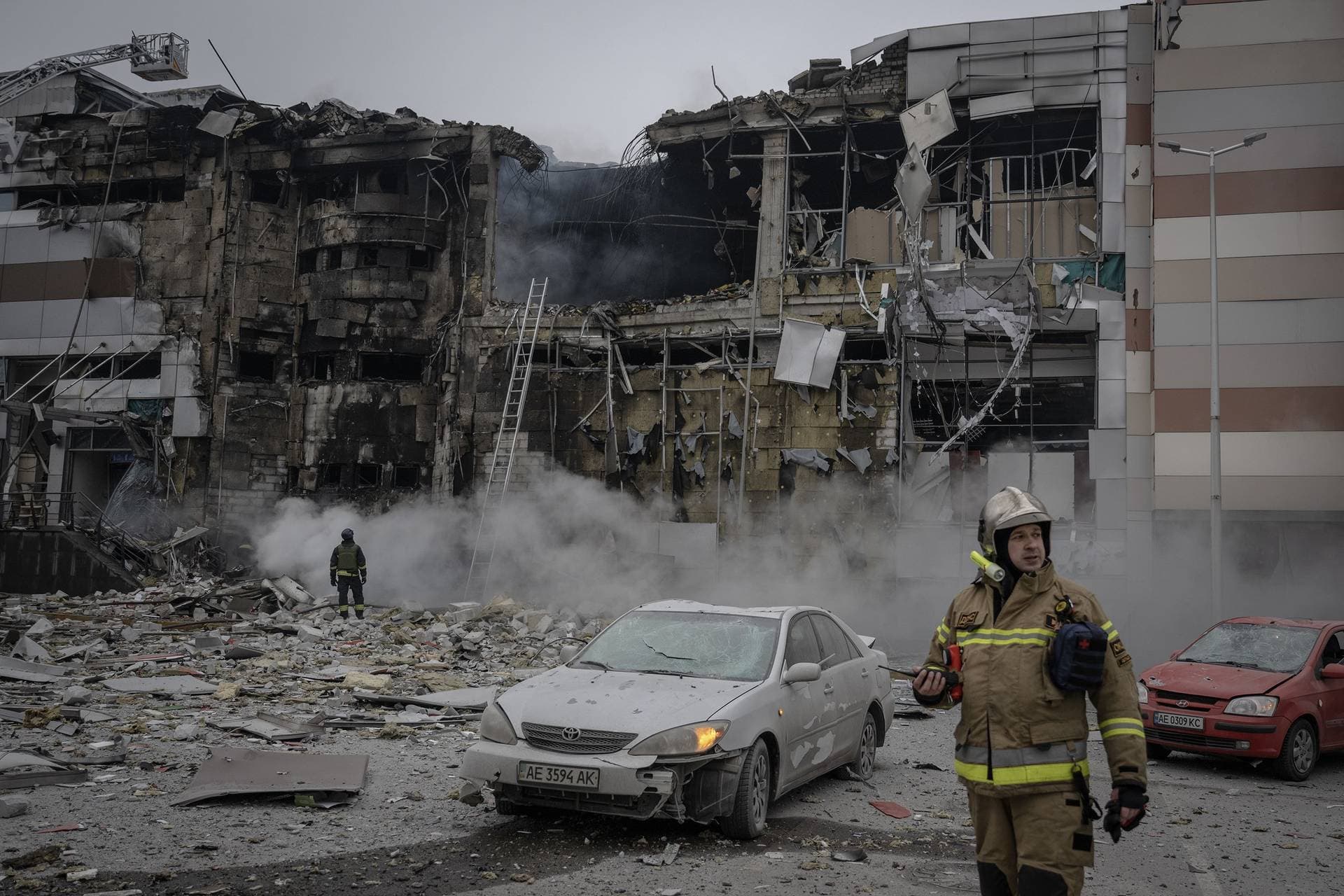 Firefighters work in the ruins of a shopping centre damaged in Dnipro