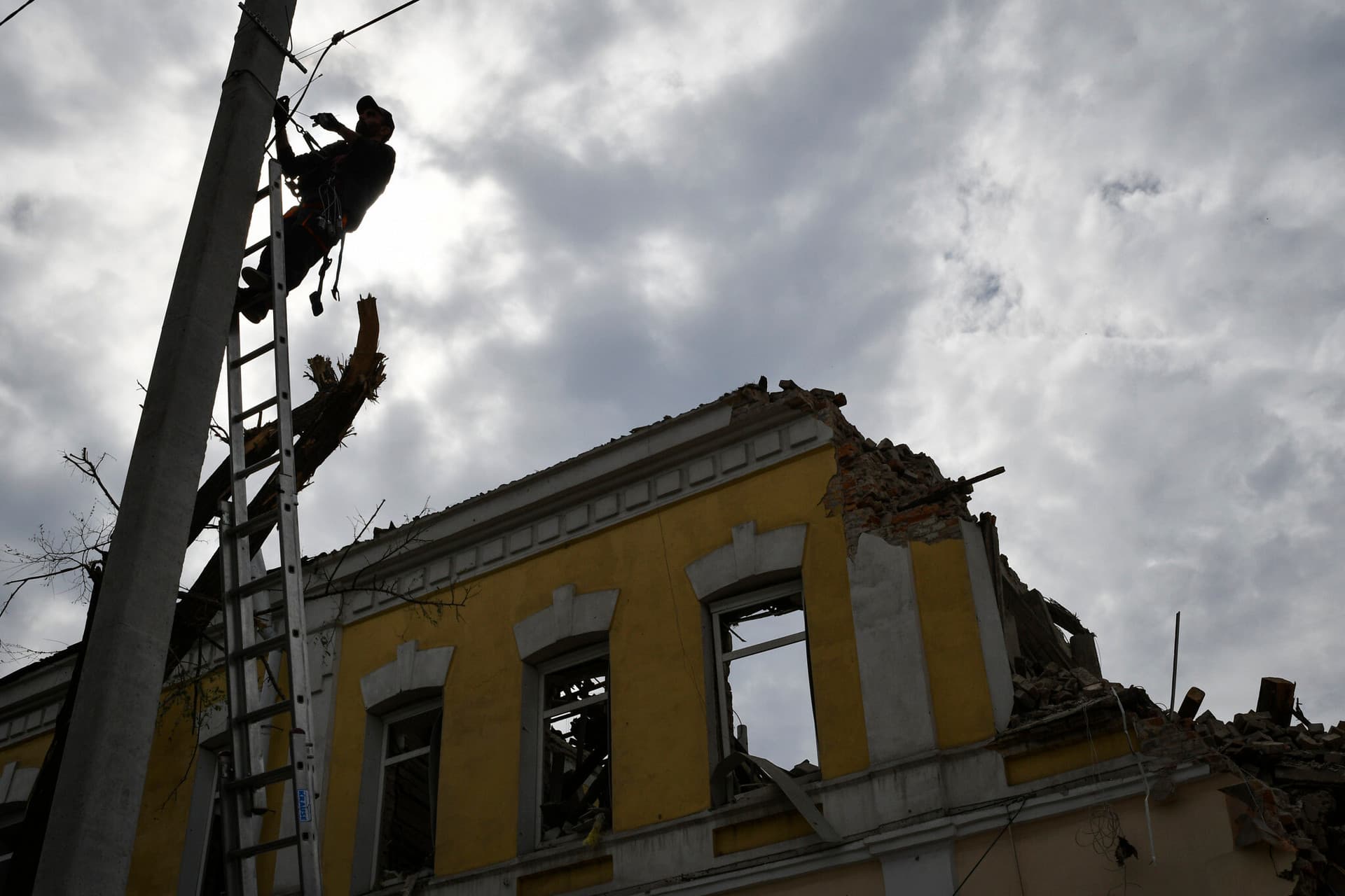 A technician restores power after latest Russian rocket attack in Dnipro