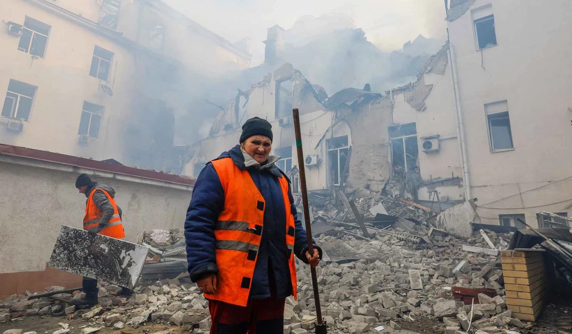 Municipal workers remove debris outside a local railway administration headquarters in Donetsk