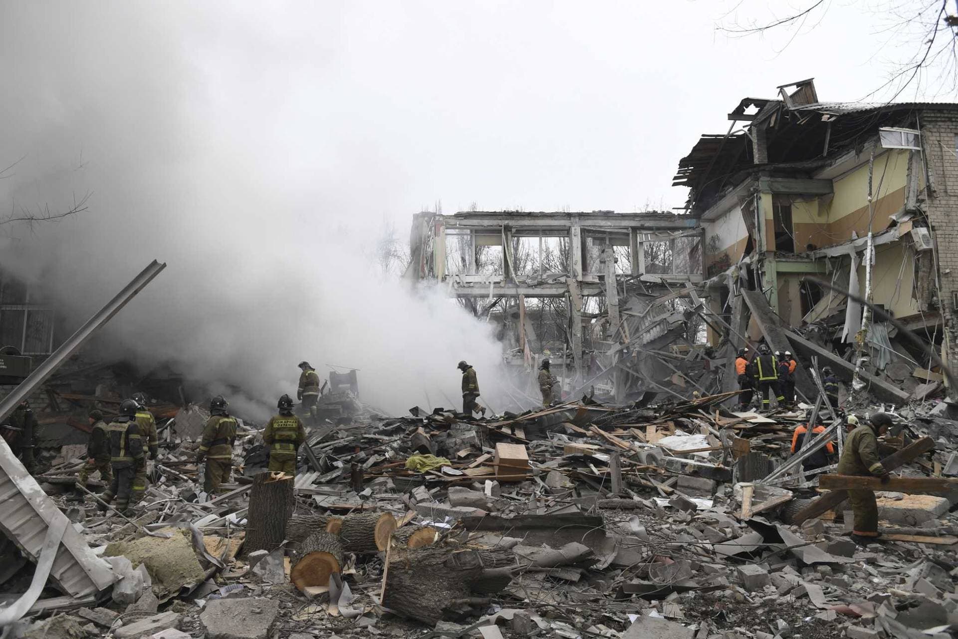Donetsk's emergency employees work at a site of a destroyed shopping center in Donetsk