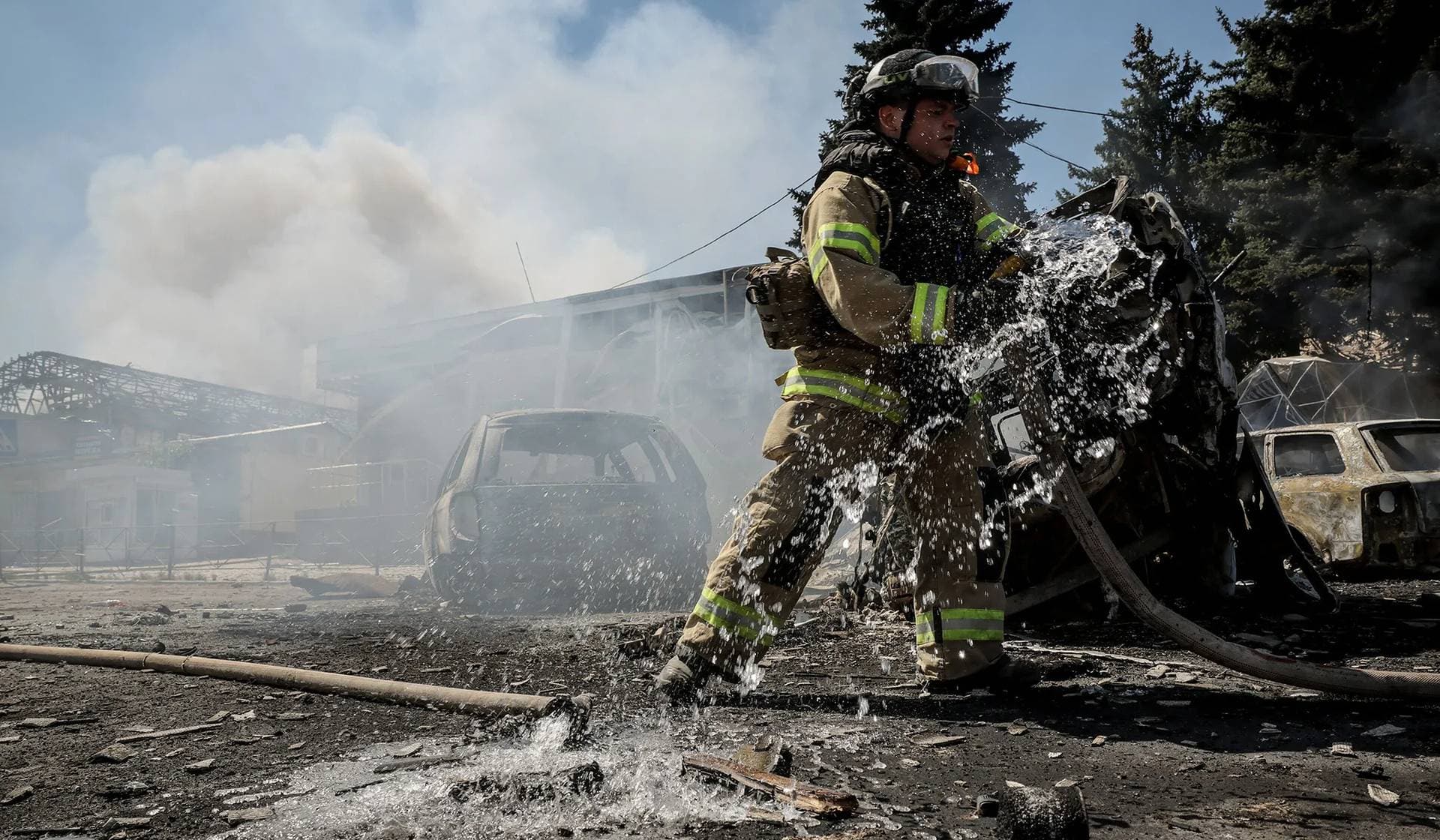 firefighter works at the site of a Russian drone strike in Druzhkivka
