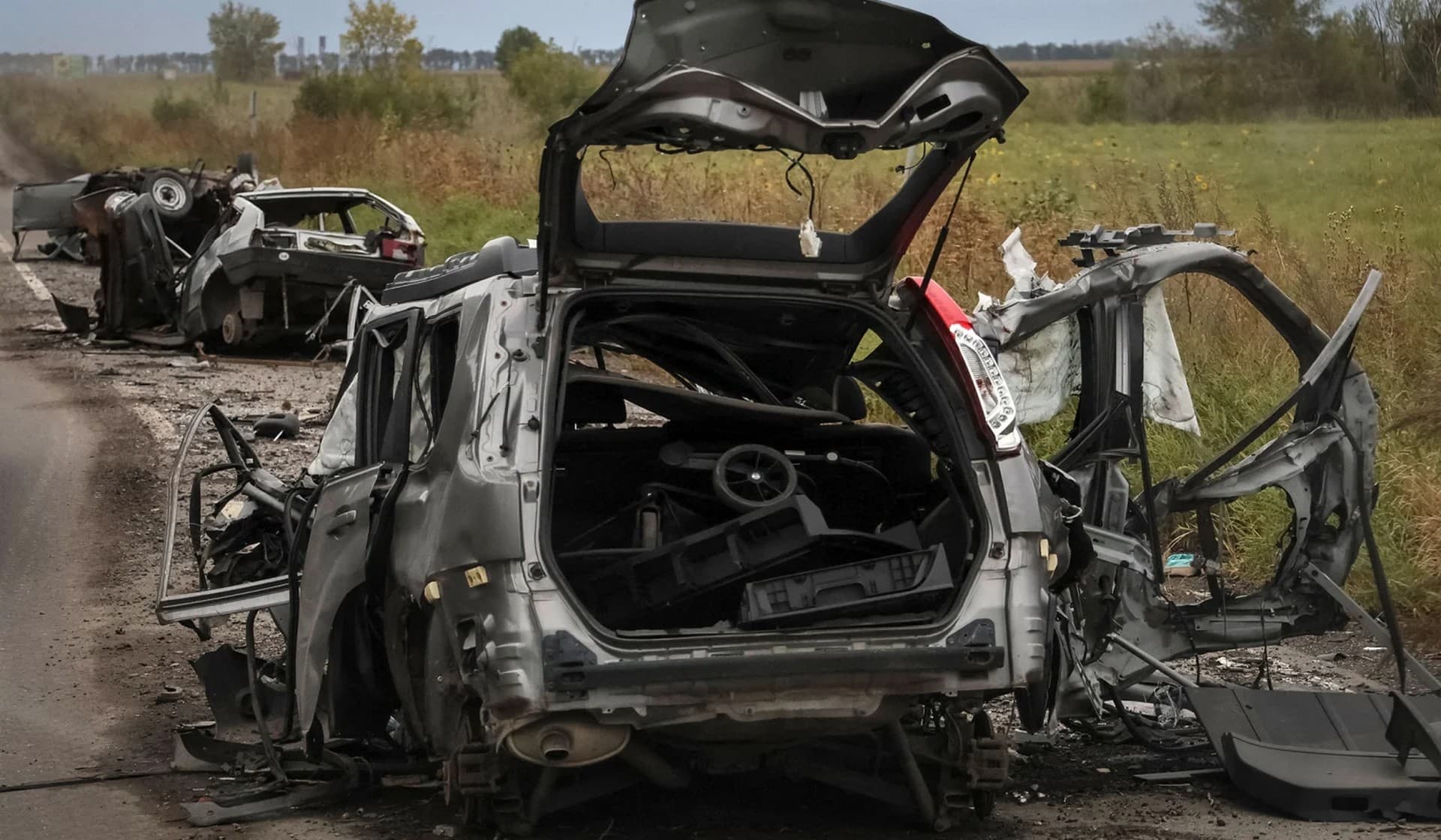 Destroyed civilian cars on a road near the town of Balakliia