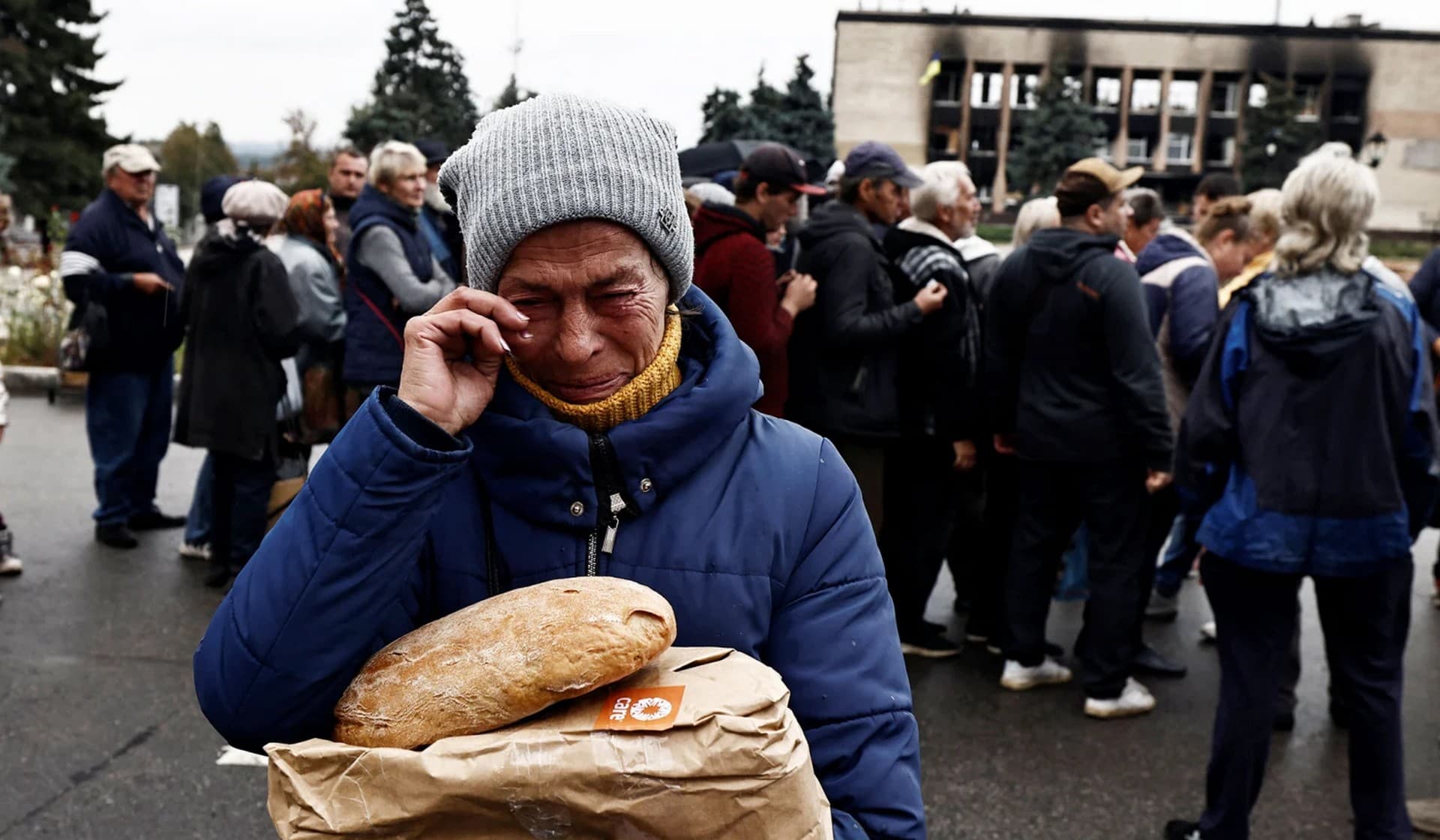 Nina Shevchenko, 65, reacts after she received humanitarian aid in the recently liberated town of Izium