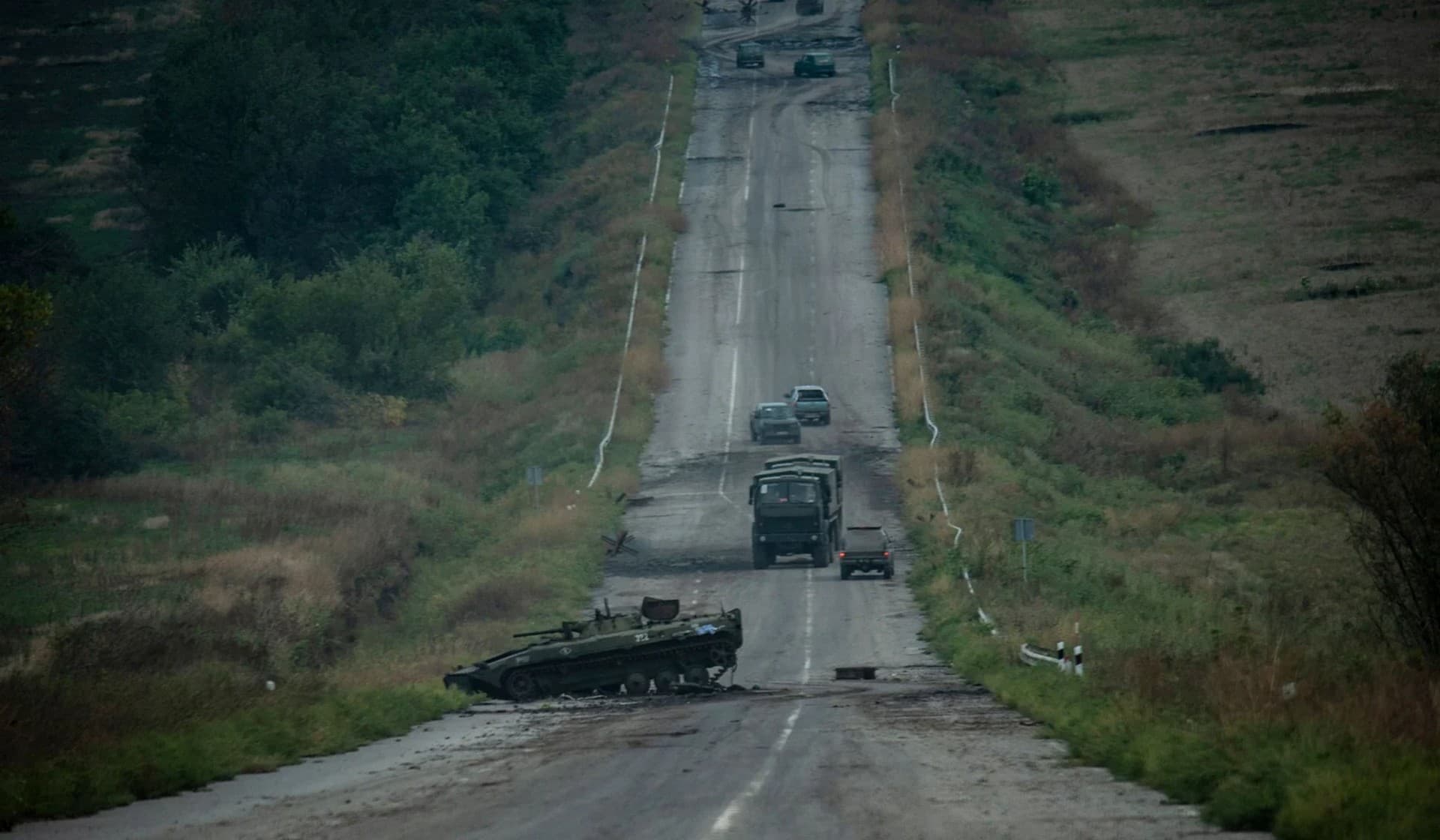 A destroyed armored fighting vehicle on a road near the town of Izium