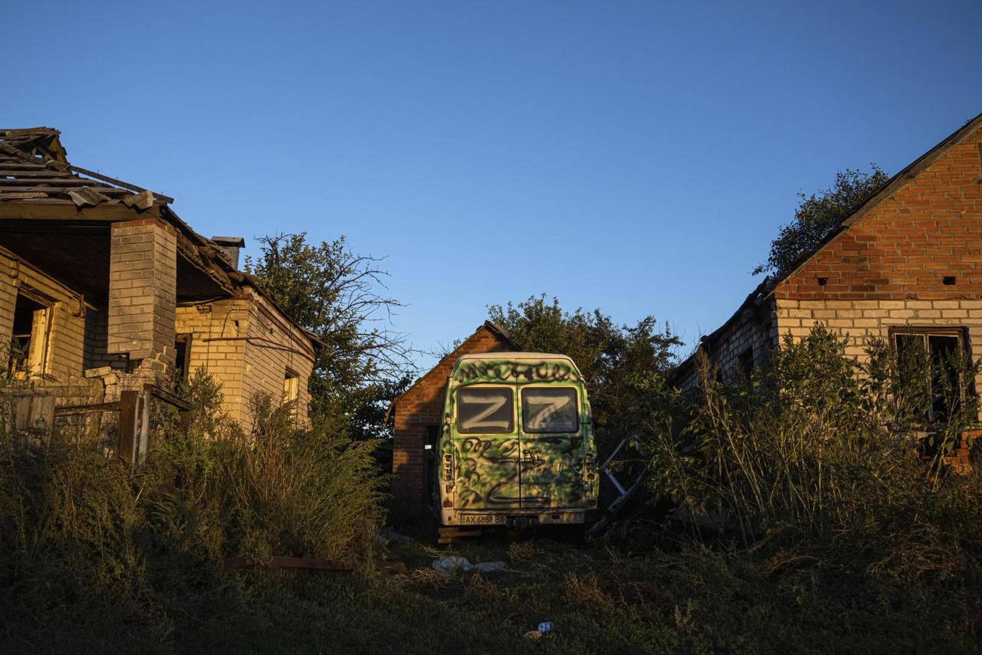 A van with sign 'Z' is parked in a residential neighbourhood of the recently retaken area of Kamyanka