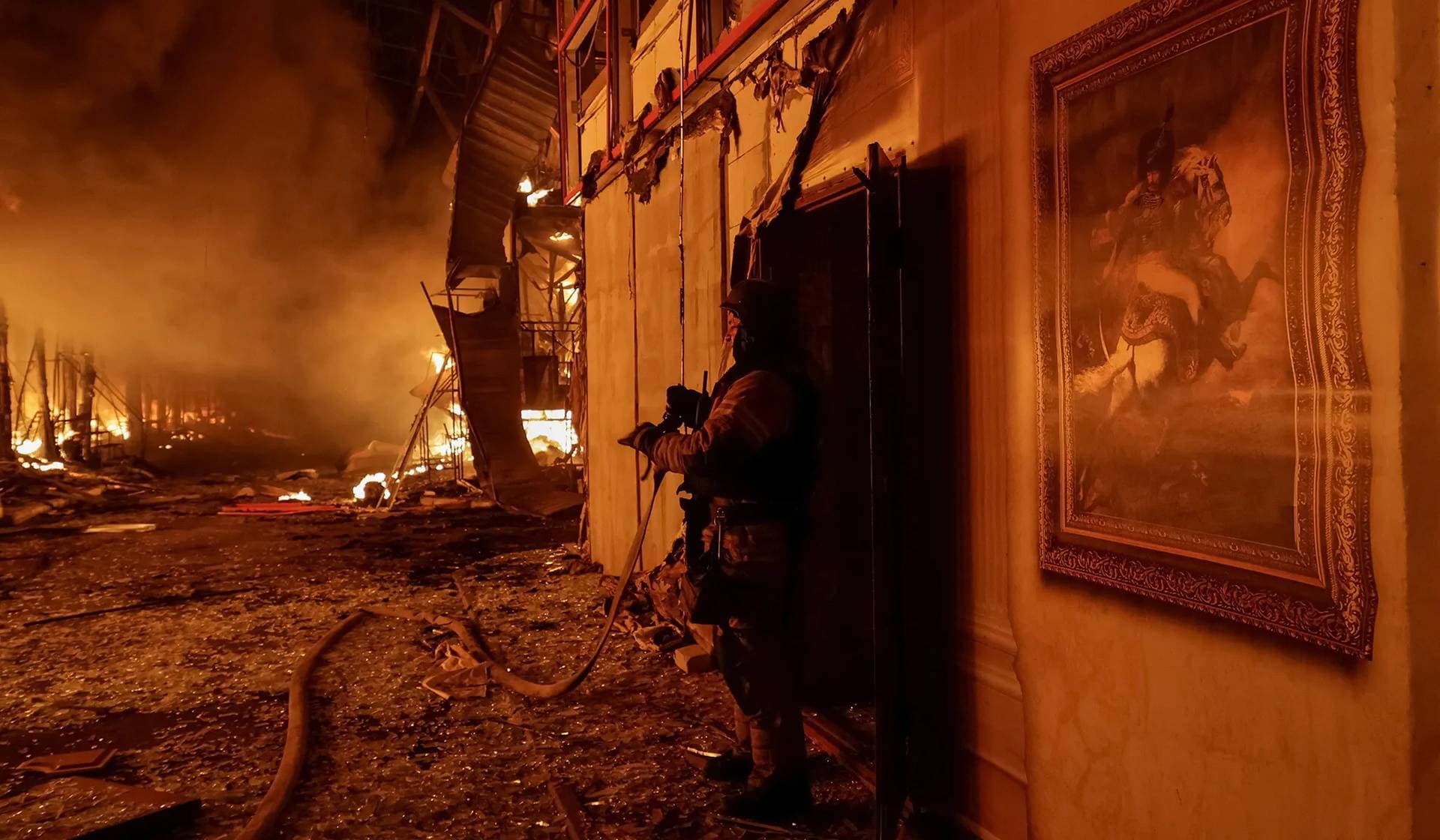 Firefighters work at the site of the Barabashovo market hit by Russian drone strike in Kharkiv