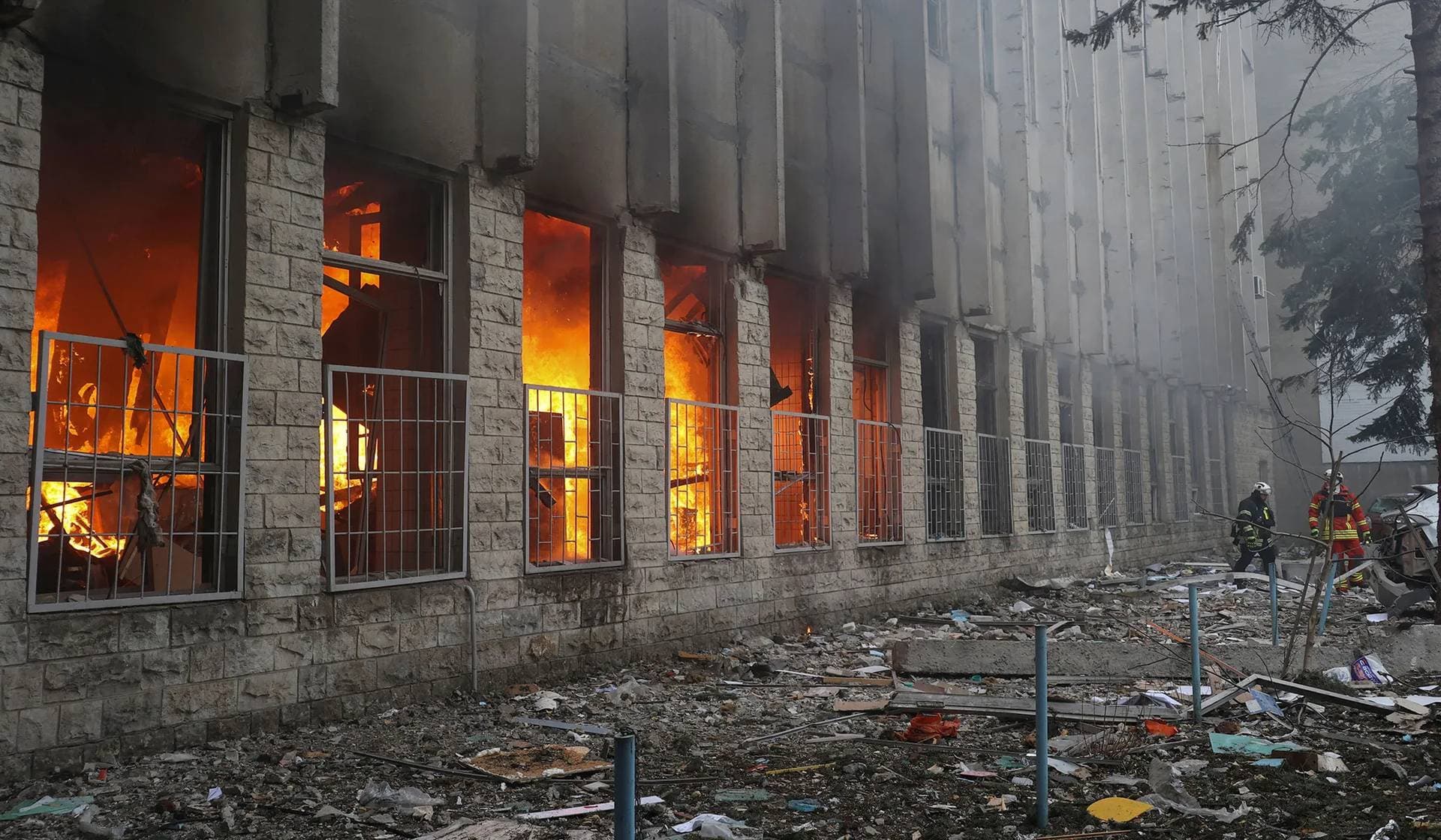 Firefighters work at a site of a printing house hit by a Russian missile strike in Kharkiv