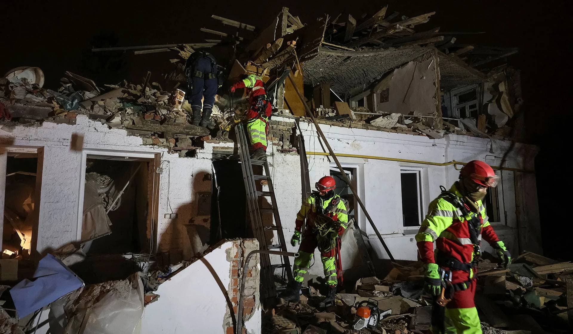 Rescuers work at a site of an apartment building hit by a Russian missile strike in Kharkiv
