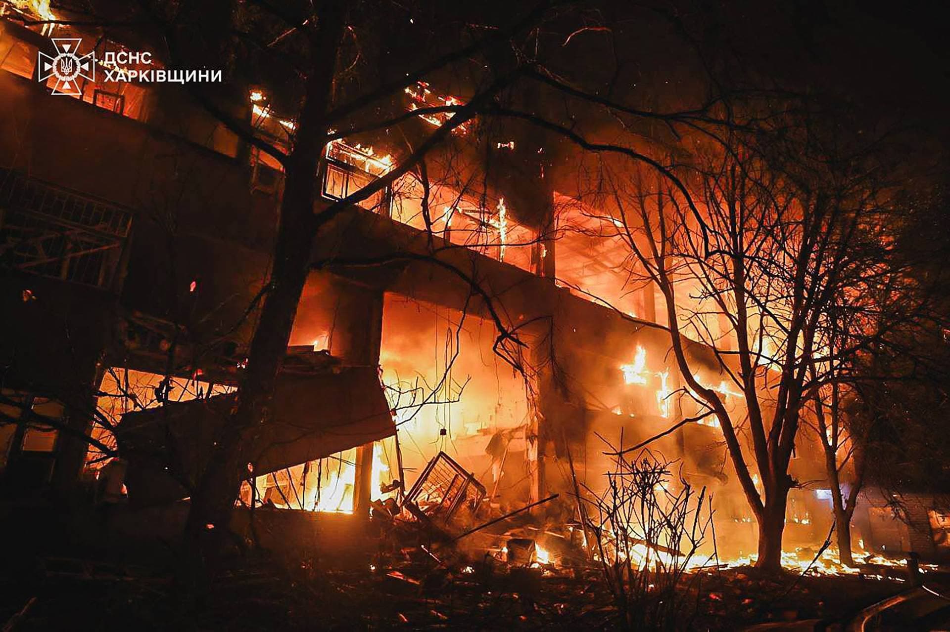 Flames rise from a building following a Russian drone strike in Kharkiv