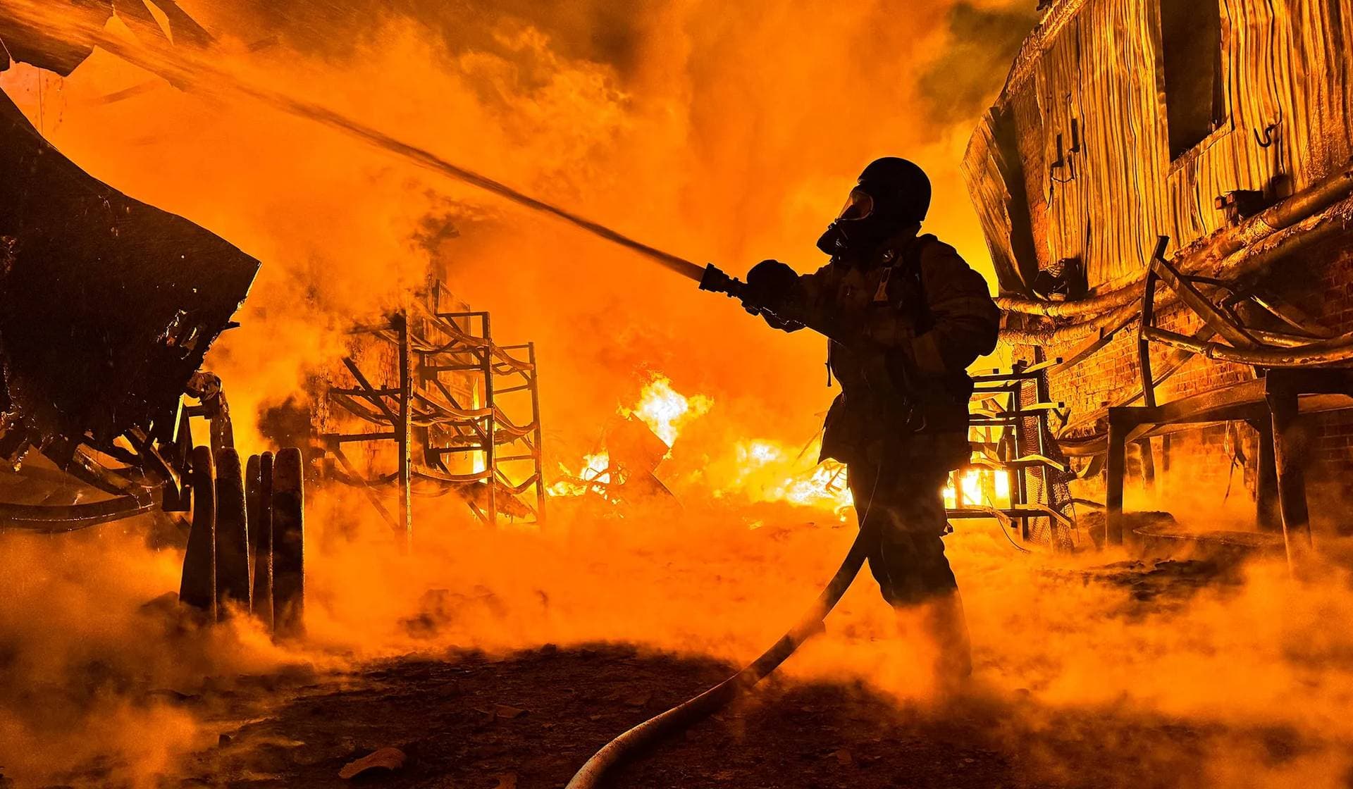 A firefighter works at a site of a Russian drone strike in Kharkiv