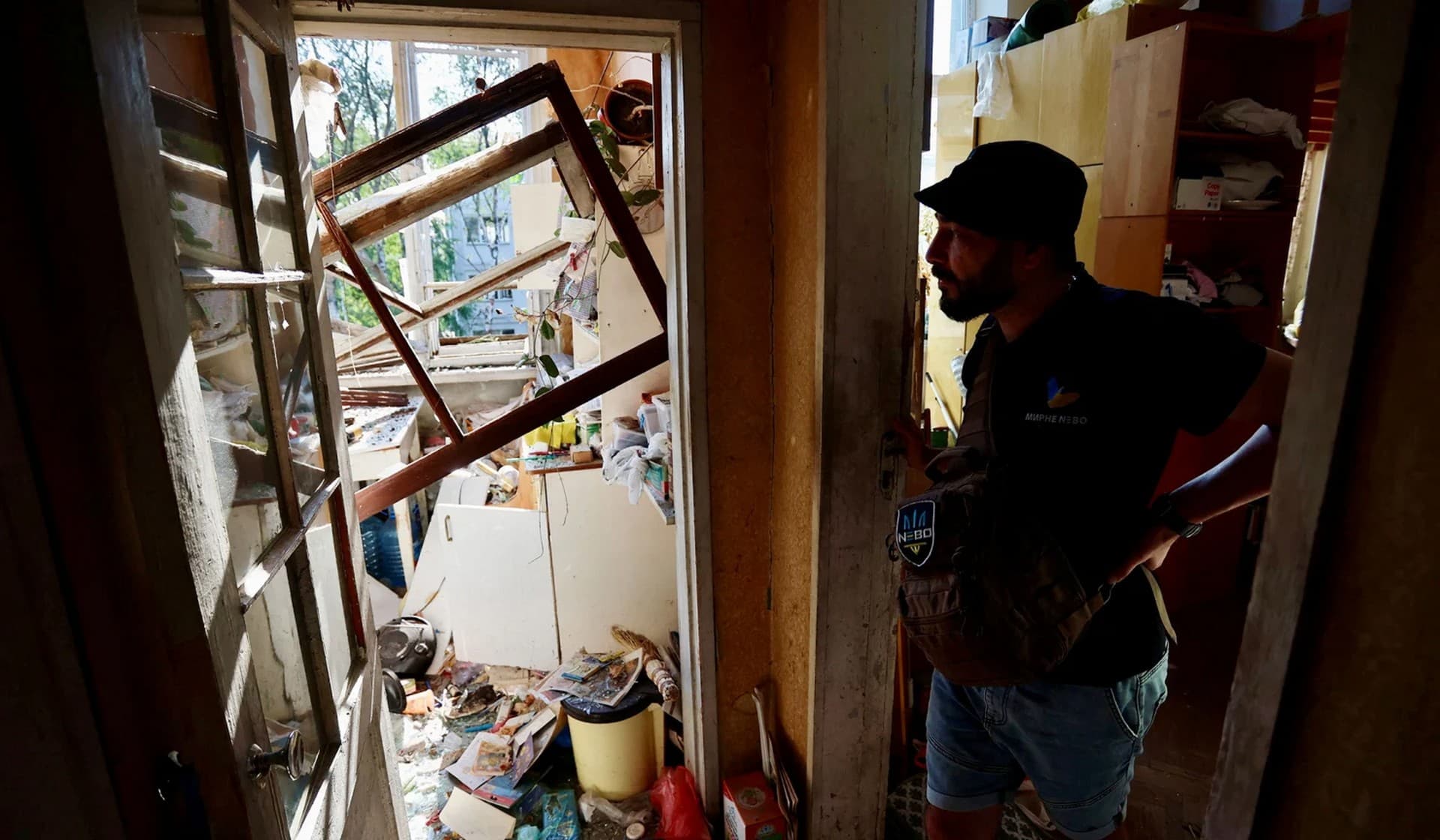 Local resident Oleksii Mazurchuk inspects his apartment in a residential building destroyed by Russian military strike in central Kharkiv
