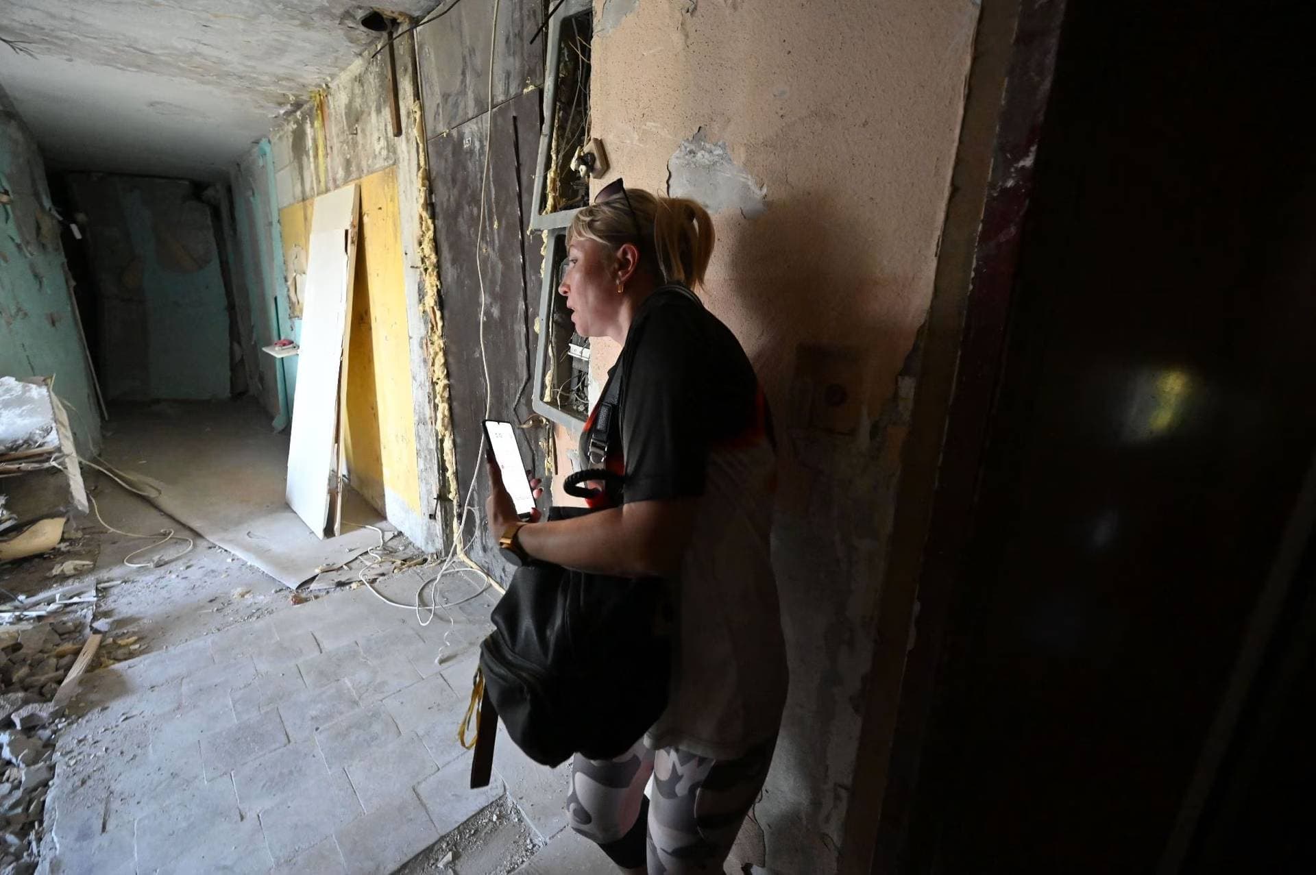 Tetiana Bezatosna walks to visit her destroyed flat