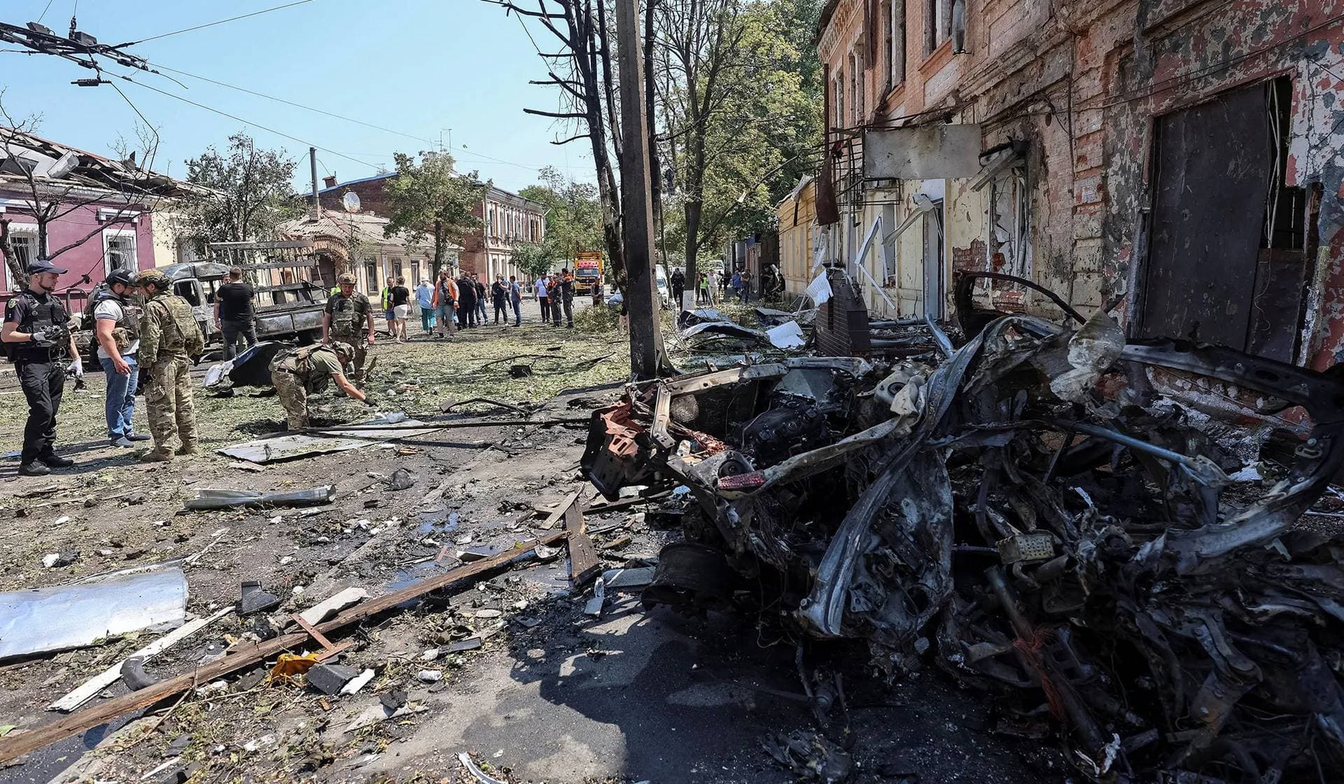 Police experts work at the site of the Russian drone strike in Kharkiv