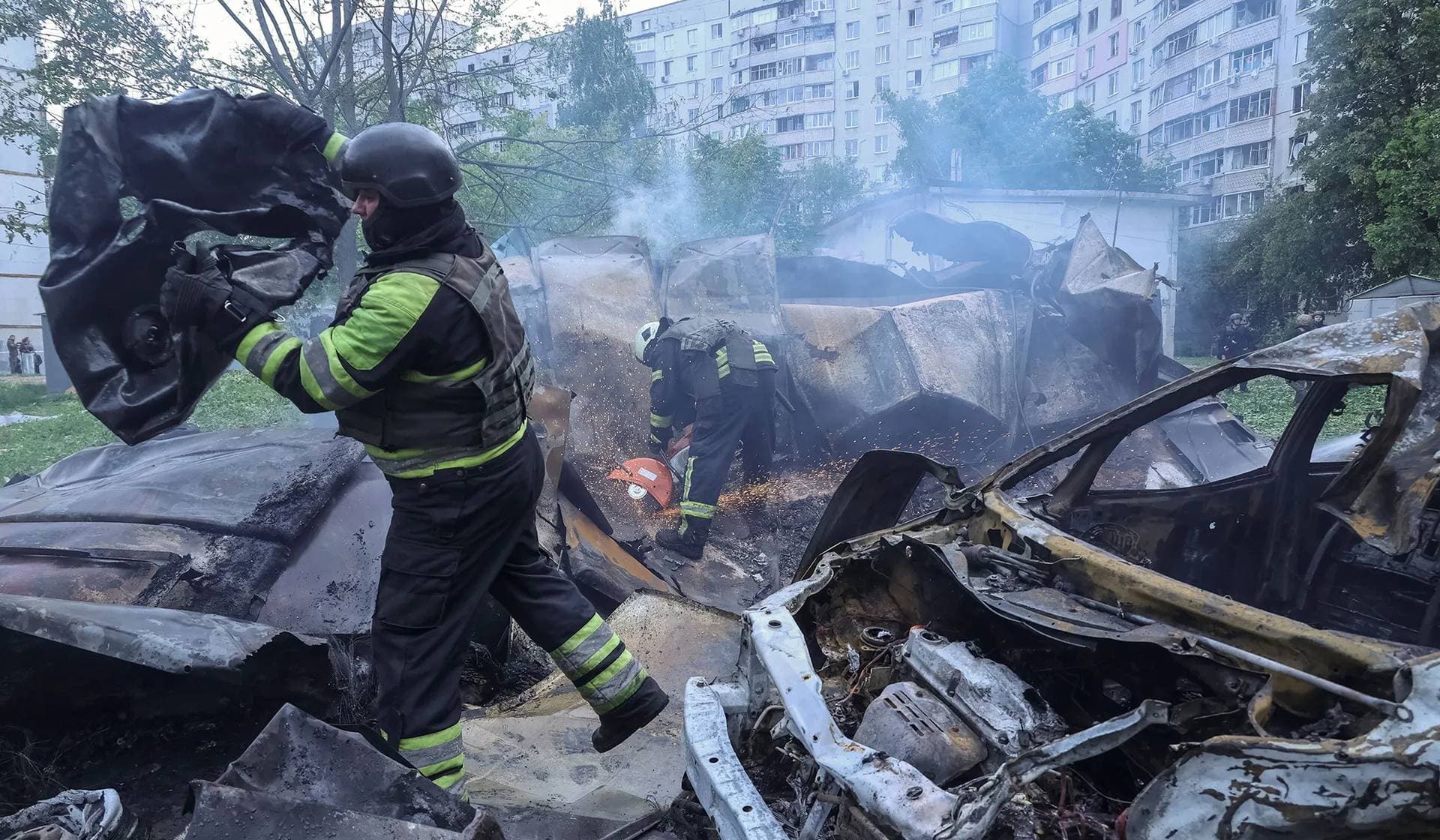 Firefighters work at the site of a Russian air strike in Kharkiv