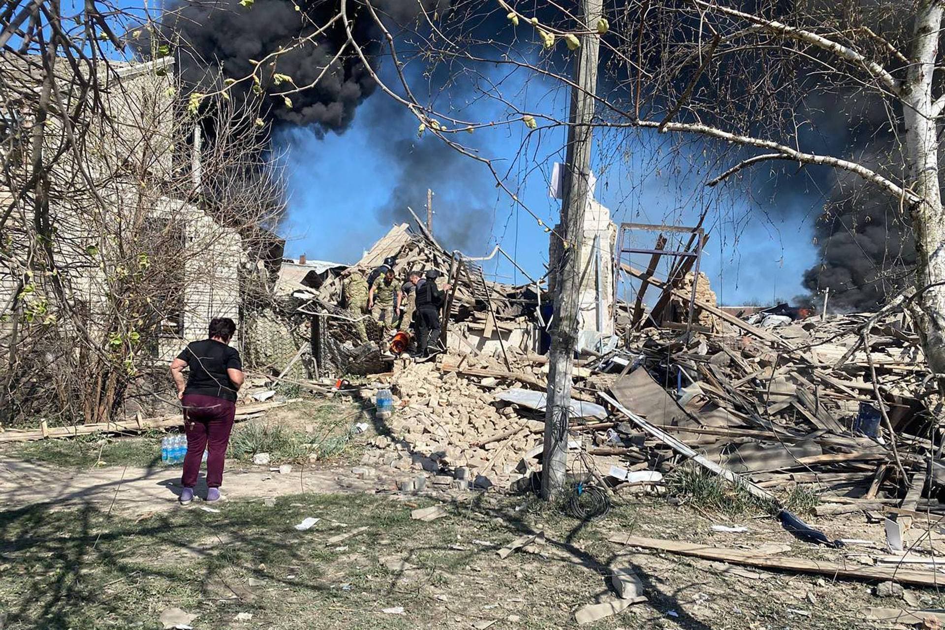 Firefighters work at the site of the Kids and Youth Sport Riding School heavily damaged by Russian missile strikes in the village of Mala Danylivka outside Kharkiv